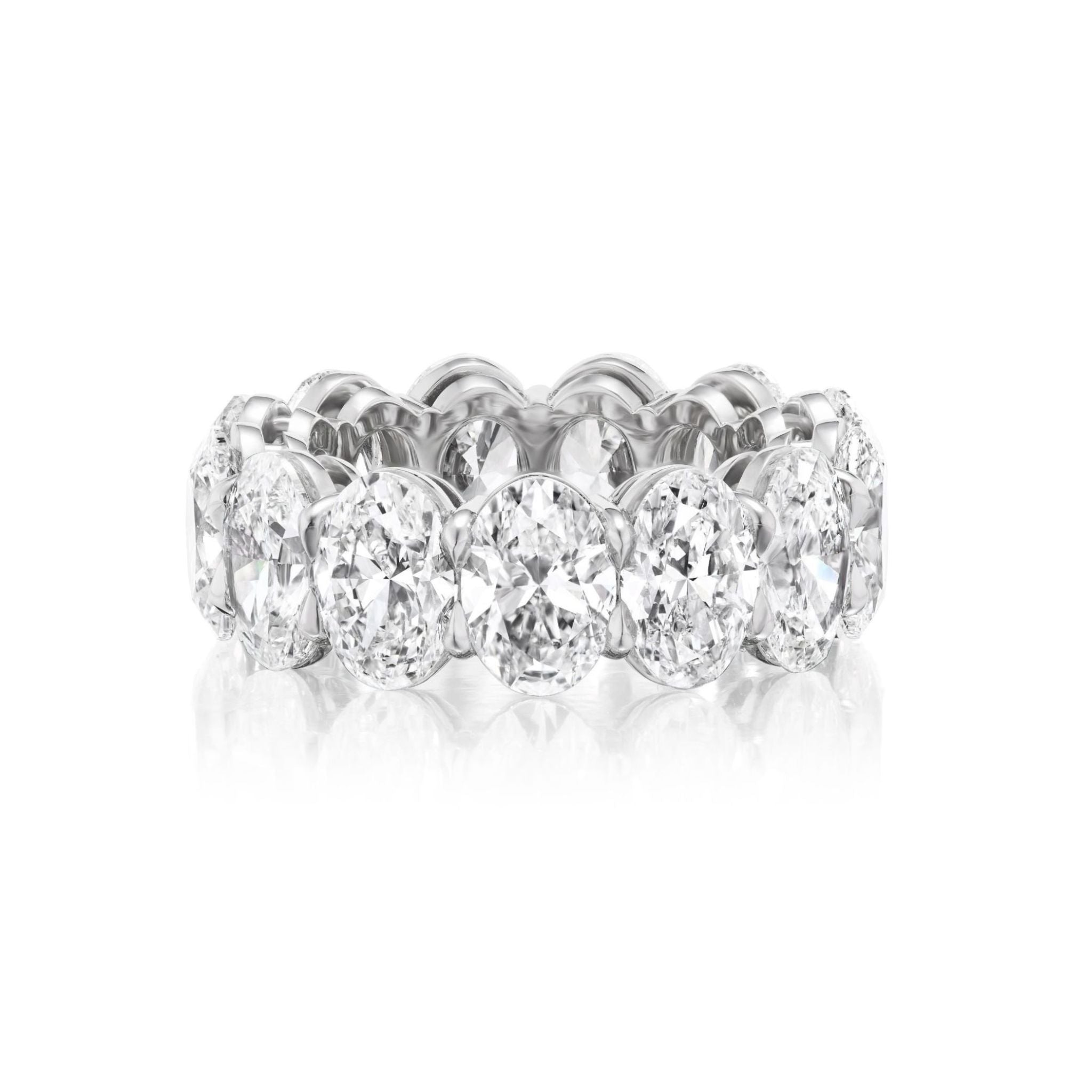 The Oval Diamond Platinum Eternity Band features large, oval-cut diamonds set all around a sleek platinum band and is beautifully photographed on a white background. Ideal as a bridal band or for anyone seeking an elegant and brilliant celebration ring.