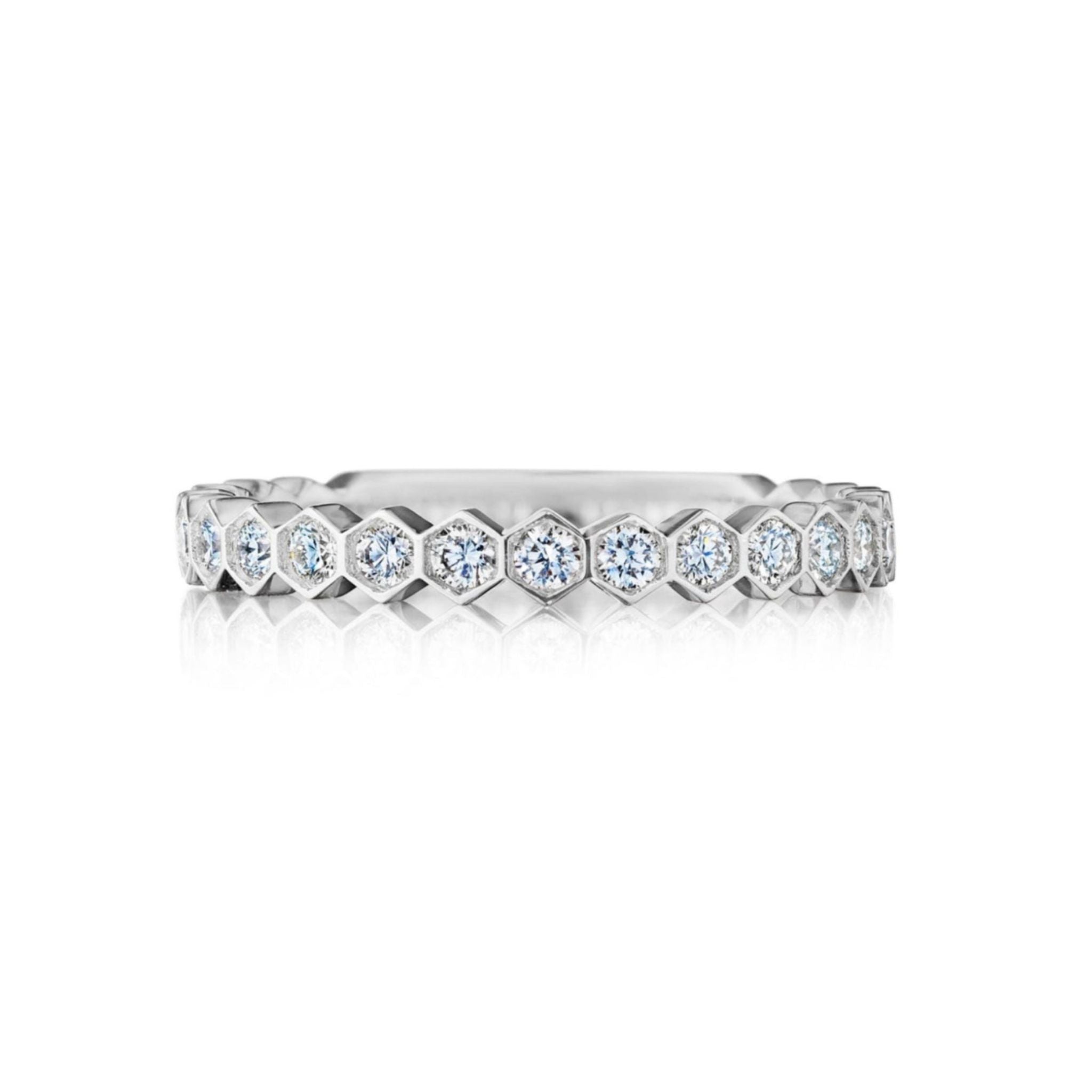 The Hexagon Bezel Set Diamond Band, crafted in silver and adorned with round brilliant diamonds set in hexagonal bezels encircling the entire band, is showcased against a white background.