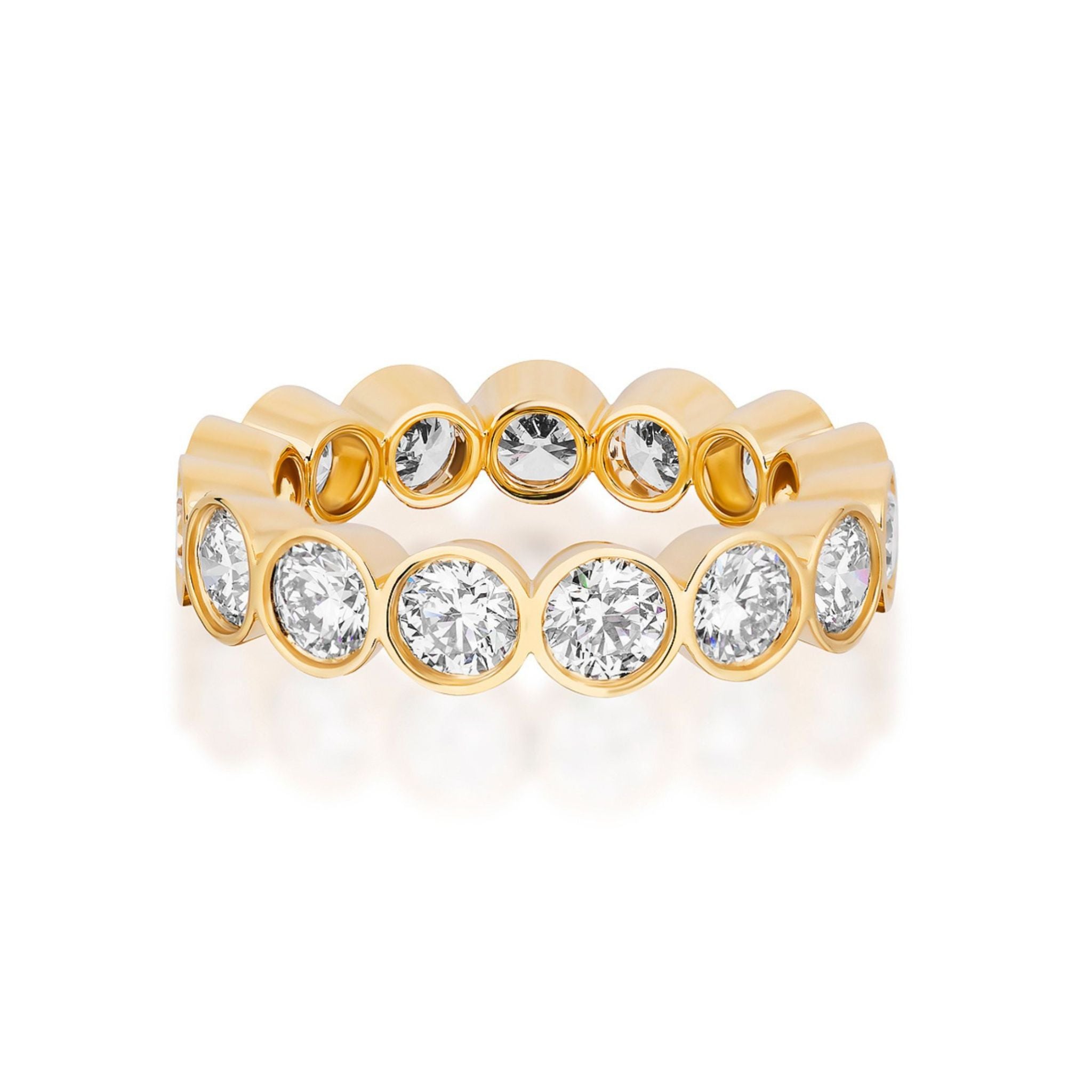 Introducing the Bezel Set Round Brilliant Diamond Eternity Band: a yellow gold band adorned with round, bezel-set diamonds that wrap seamlessly around the entire ring. Shown against a white background, this ring makes an elegant engagement choice or a timeless addition to any custom bridal ring collection.