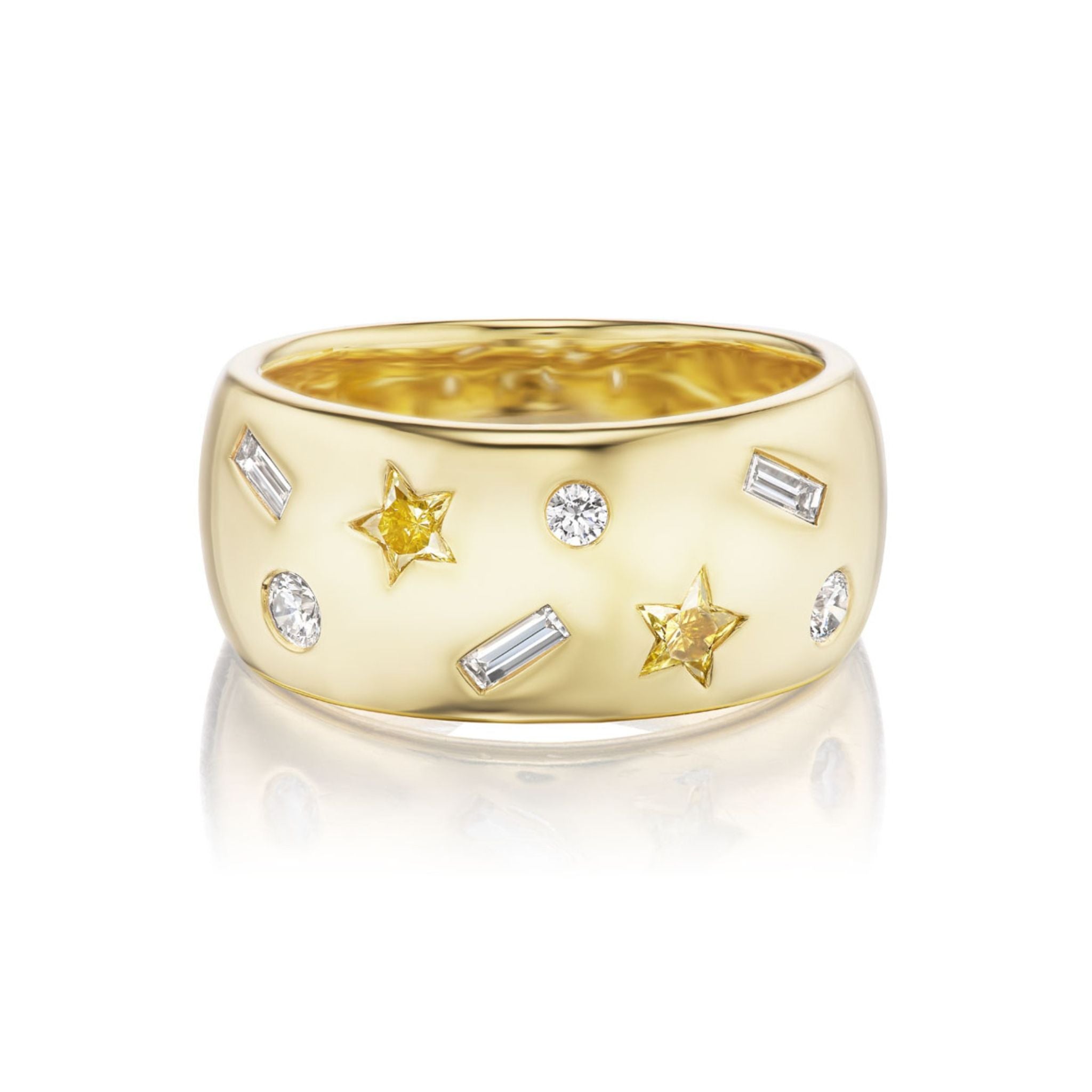 The Yellow Diamond Celestial Cigar Band is a wide 18k yellow gold ring showcasing a yellow star and round brilliant white gemstones, including baguette-cut stones, arranged in a scattered pattern across its polished, reflective surface.