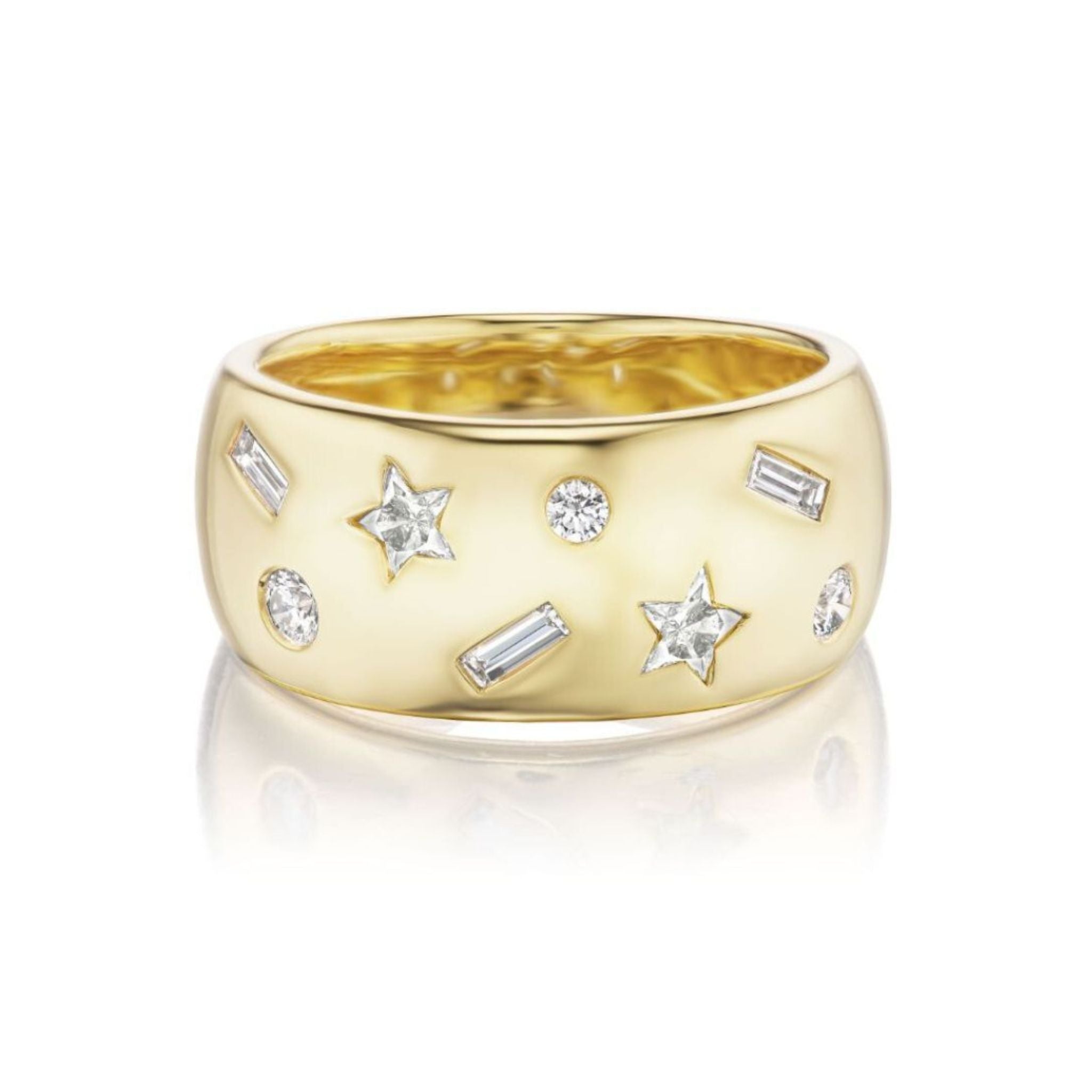 The Celestial Cigar Band in Yellow Gold with Mixed Shape Diamonds shines in lustrous 18k yellow gold, adorned with star, round, and baguette diamond accents on a sleek polished band—a celestial jewelry piece displayed on a white reflective surface.