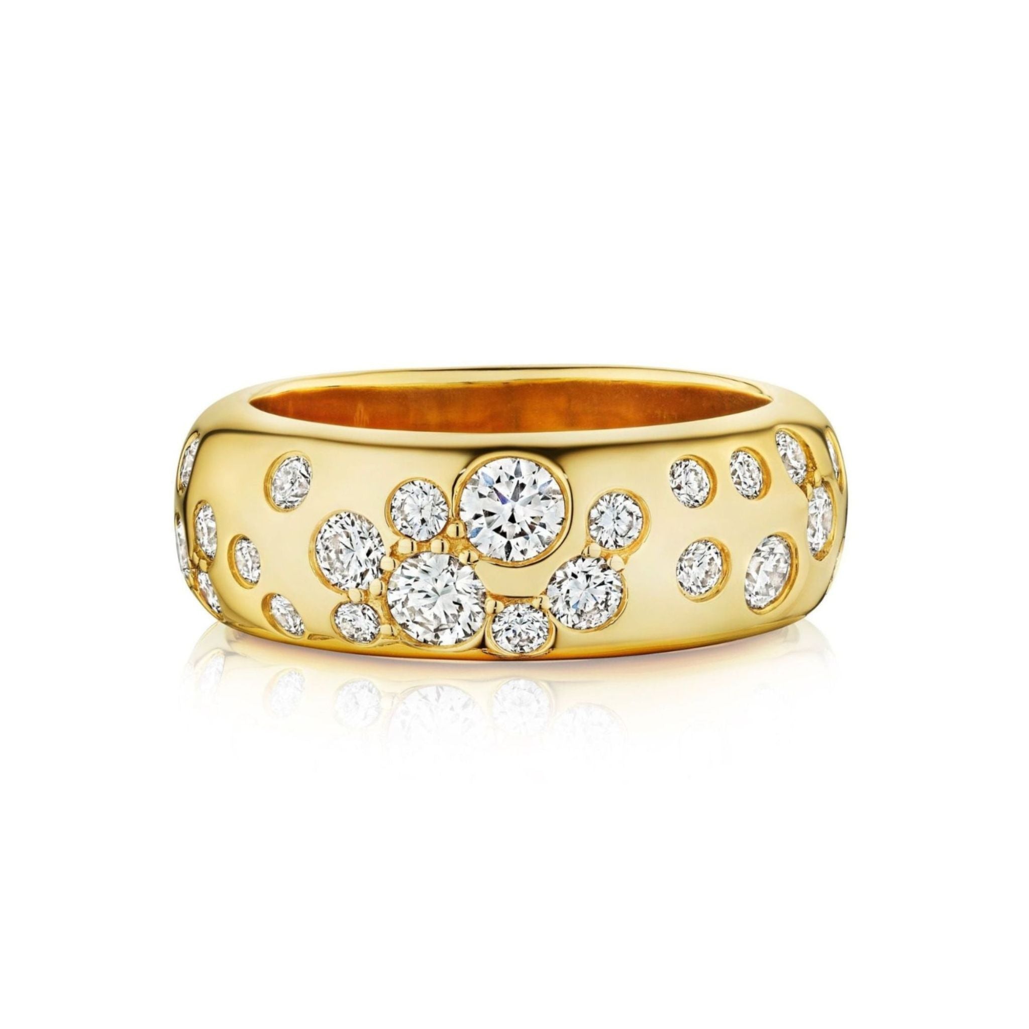 The Cluster Cigar Band with Burnish Set Round Brilliant Diamonds, crafted from luxurious 18k yellow gold and adorned with multiple round brilliant diamonds of varying sizes set across its wide band, is displayed on a white background.