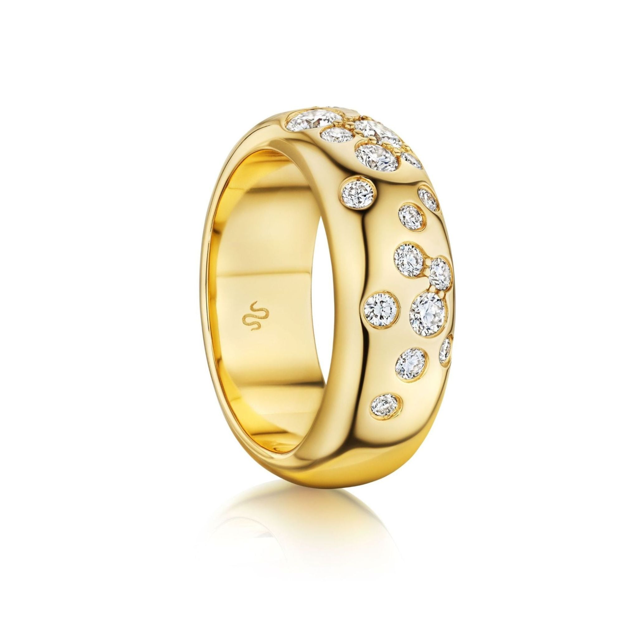 The Cluster Cigar Band with Burnish Set Round Brilliant Diamonds is a wide 18k yellow gold ring featuring a polished finish and scattered round brilliant diamonds set across the surface, displayed against a white background.