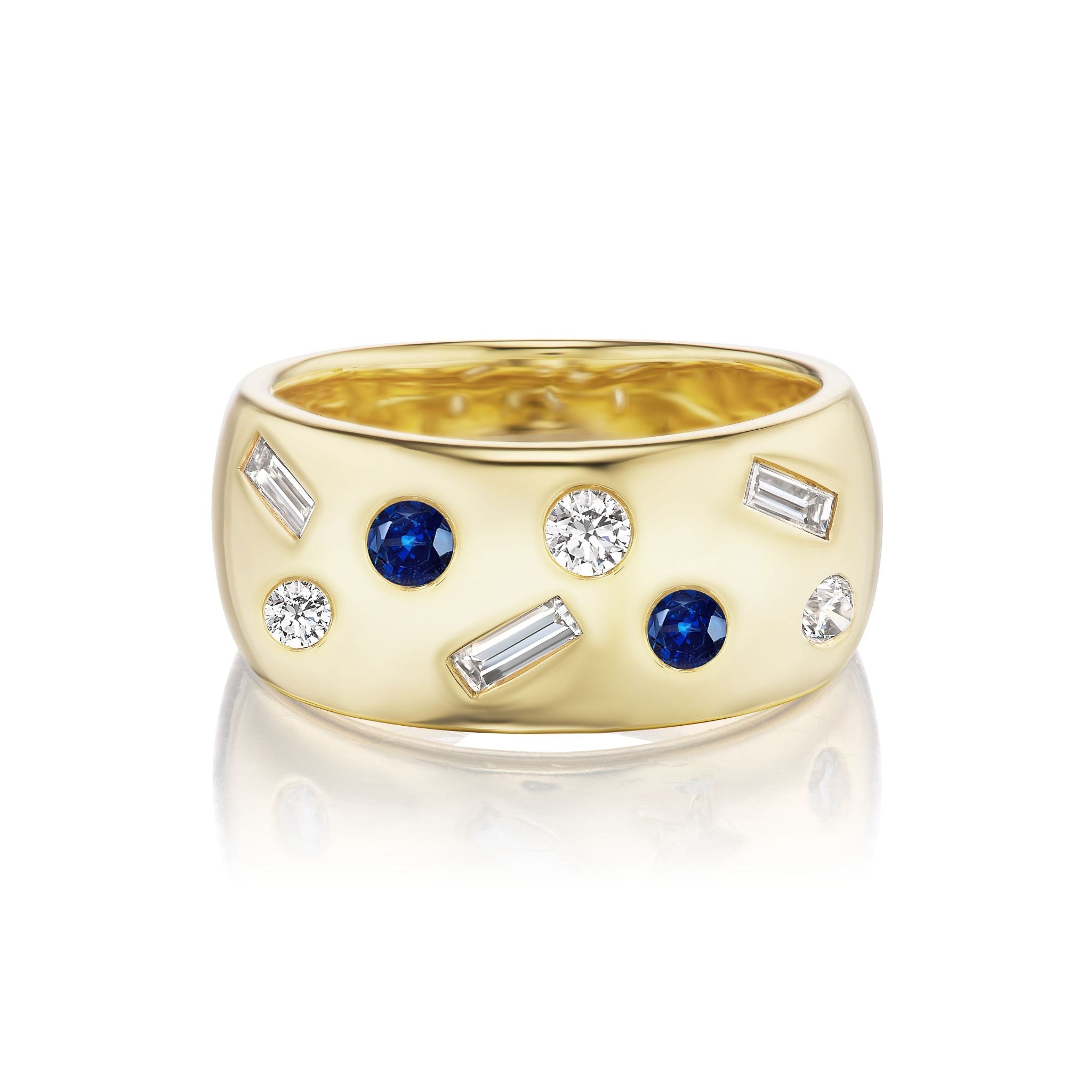 The Mixed Shape Burnish Set Diamond and Sapphire Cigar Band in Yellow Gold showcases a bold 18k yellow gold design, with round sapphires, round white diamonds, and rectangular baguette-cut diamonds burnish set in a beautifully random arrangement across its smooth surface.