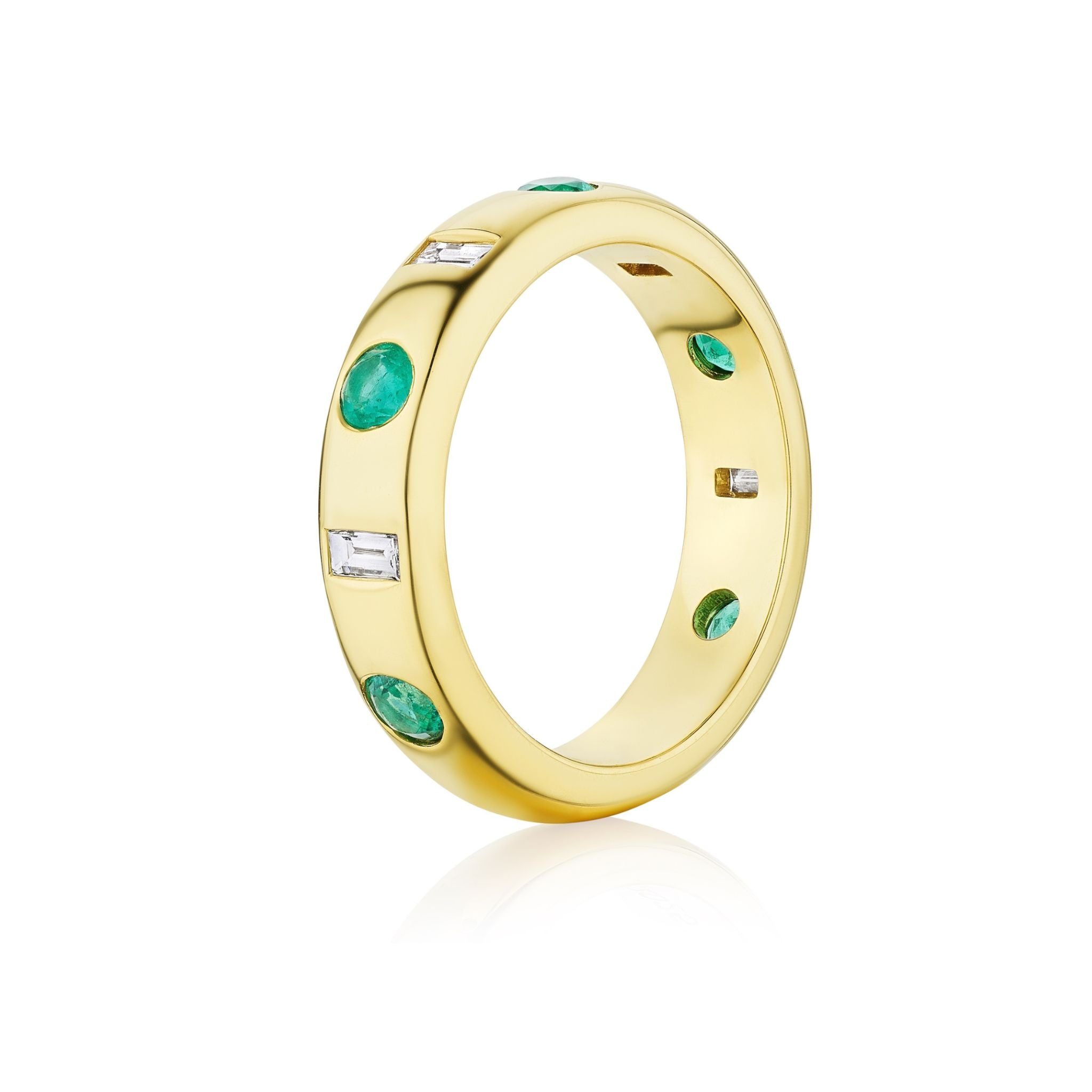 The Burnish Set Baguette Diamond and Round Emerald Band in Yellow Gold, featuring round green emeralds and rectangular baguette diamonds set evenly around the yellow gold band, photographed on a white background.