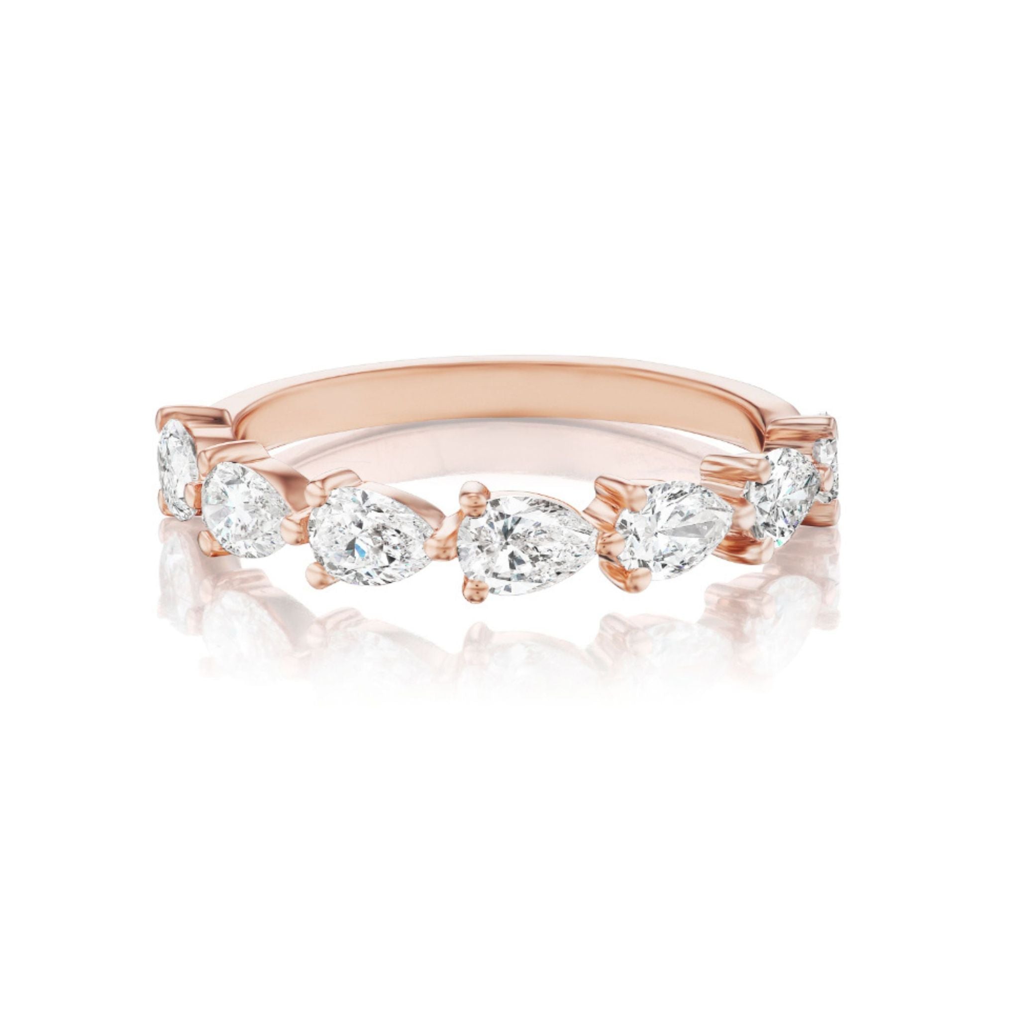 The Chasing Pears Diamond Half Eternity Band, crafted in 18k rose gold and adorned with six pear-shaped diamonds set in a row, is elegantly displayed on a white background with a subtle reflection beneath—making it a refined choice for bridal rings.