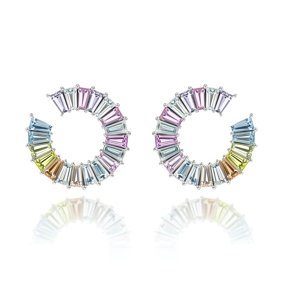 A pair of Confetti Wheel of Fortune Earrings in white gold, featuring emerald-cut diamonds and multicolor sapphires arranged in a spiral, displayed on a white reflective background.