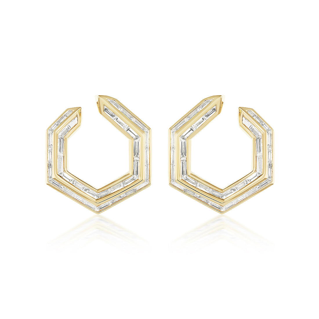 Chrysler Front-To-Back Hoops with Baguette Diamonds feature geometric hexagonal 18K gold hoops, each set with baguette diamonds outlining their modern, angular design.