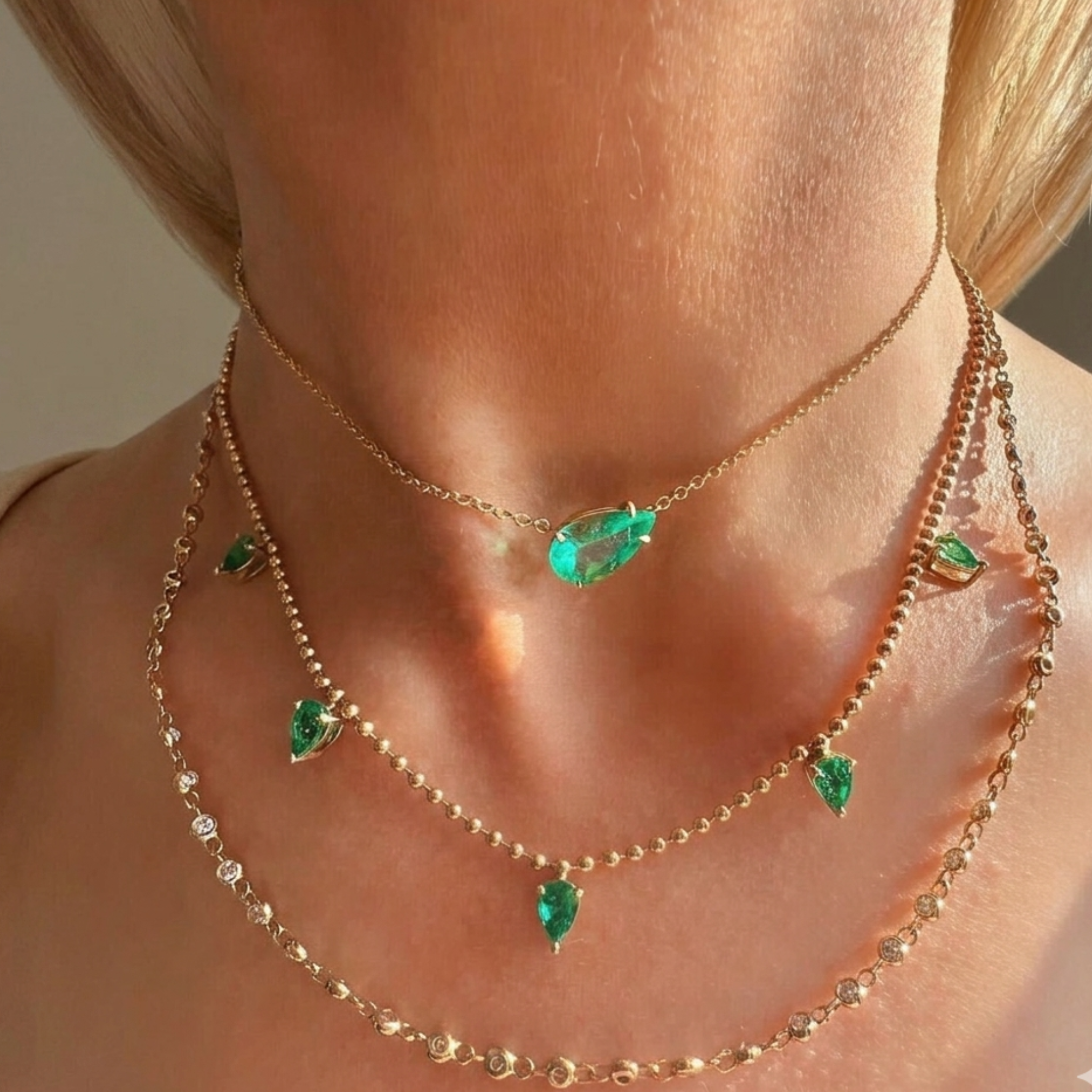 A close-up of a woman's neck wearing the Golden Garland Necklace in Yellow Gold, featuring round brilliant diamonds that catch the light in a layered look.