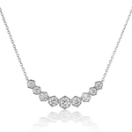 The Bezel Set Hexagon Necklace with Graduated Brilliant Diamonds features a chain with hexagonal settings, each holding a sparkling round diamond in an elegant curve—an 18k gold necklace perfect for any occasion.
