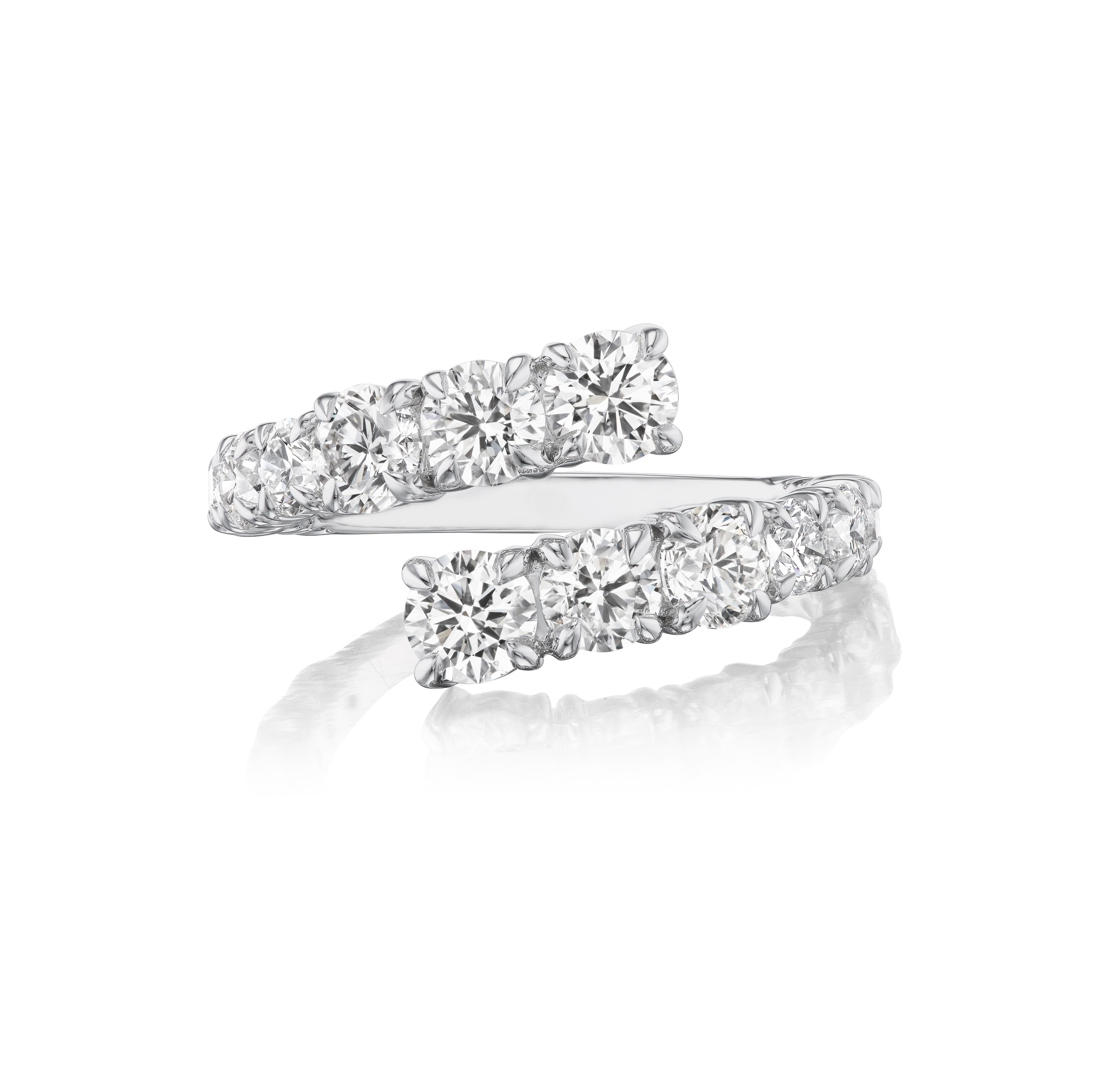 The Graduated Round Diamond Wraparound Ring in 18K white gold showcases two rows of G-H color round diamonds on each open end, displayed on a white background with a subtle reflection.