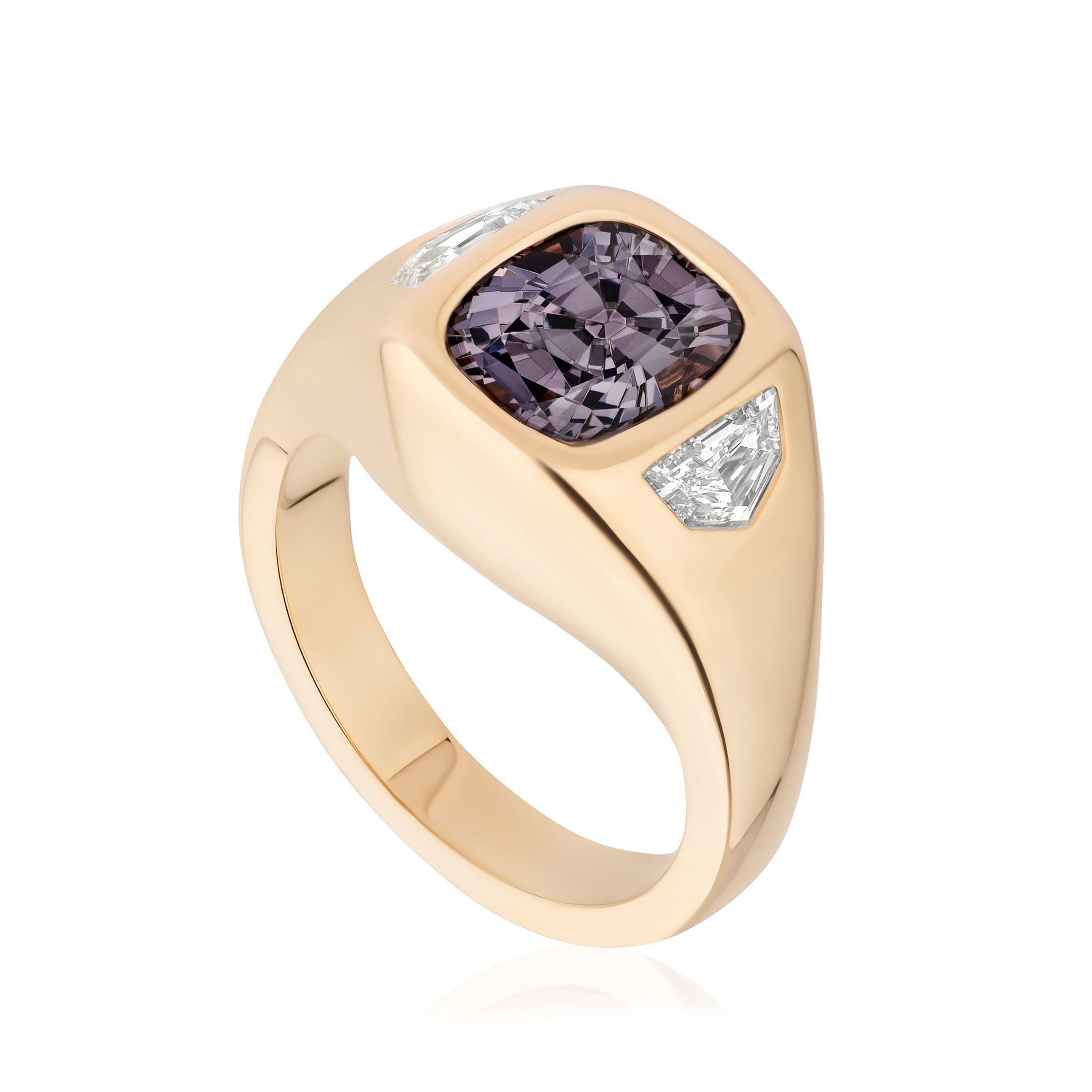 The Cushion Cut Spinel and Diamond Epaulette Side Stone Gypsy Ring features a central cushion cut spinel with diamond side stones, all set in an elegant 18K yellow gold band.