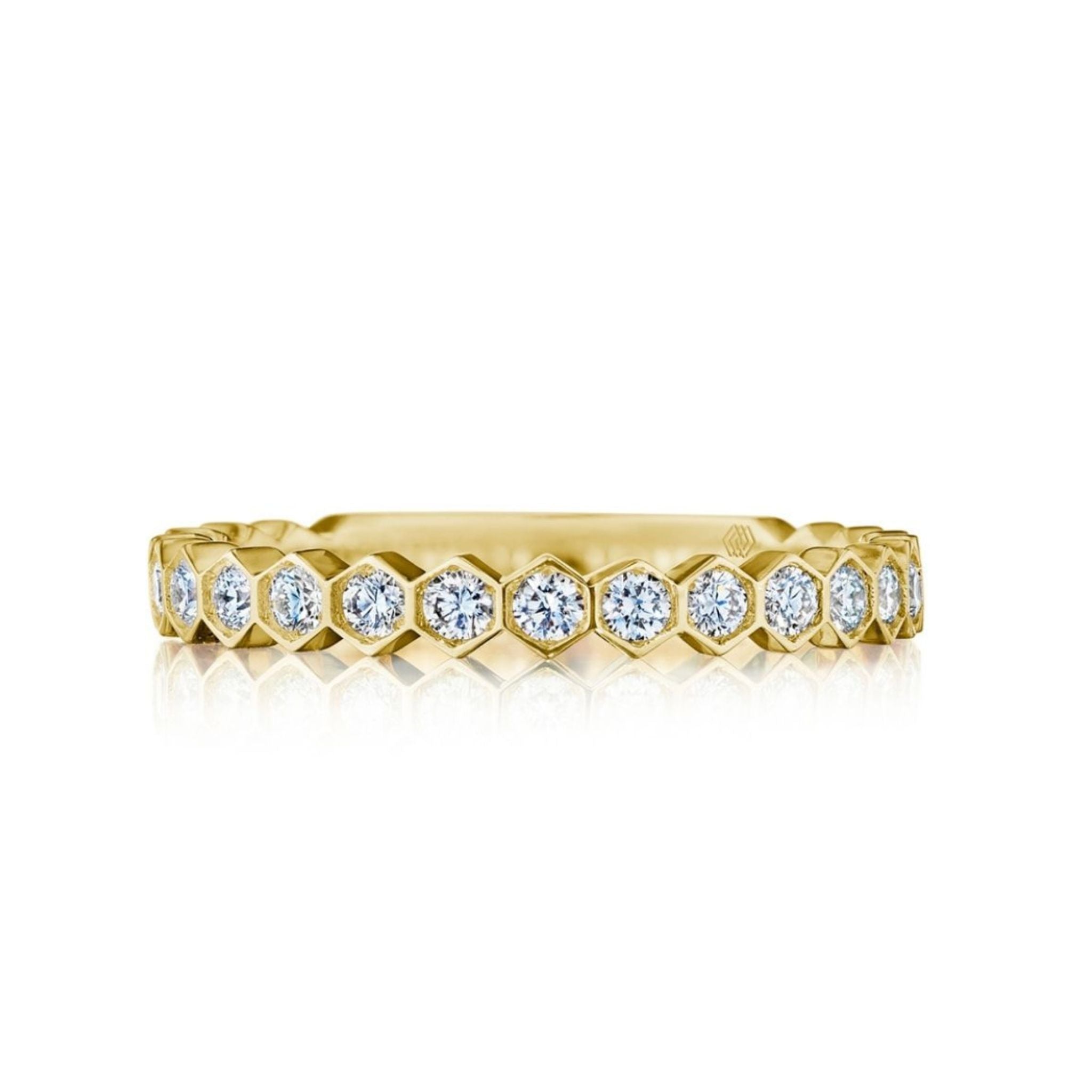The Hexagon Bezel Set Diamond Band features round diamonds in individual hexagonal bezels, creating a geometric eternity band design in 18K gold.