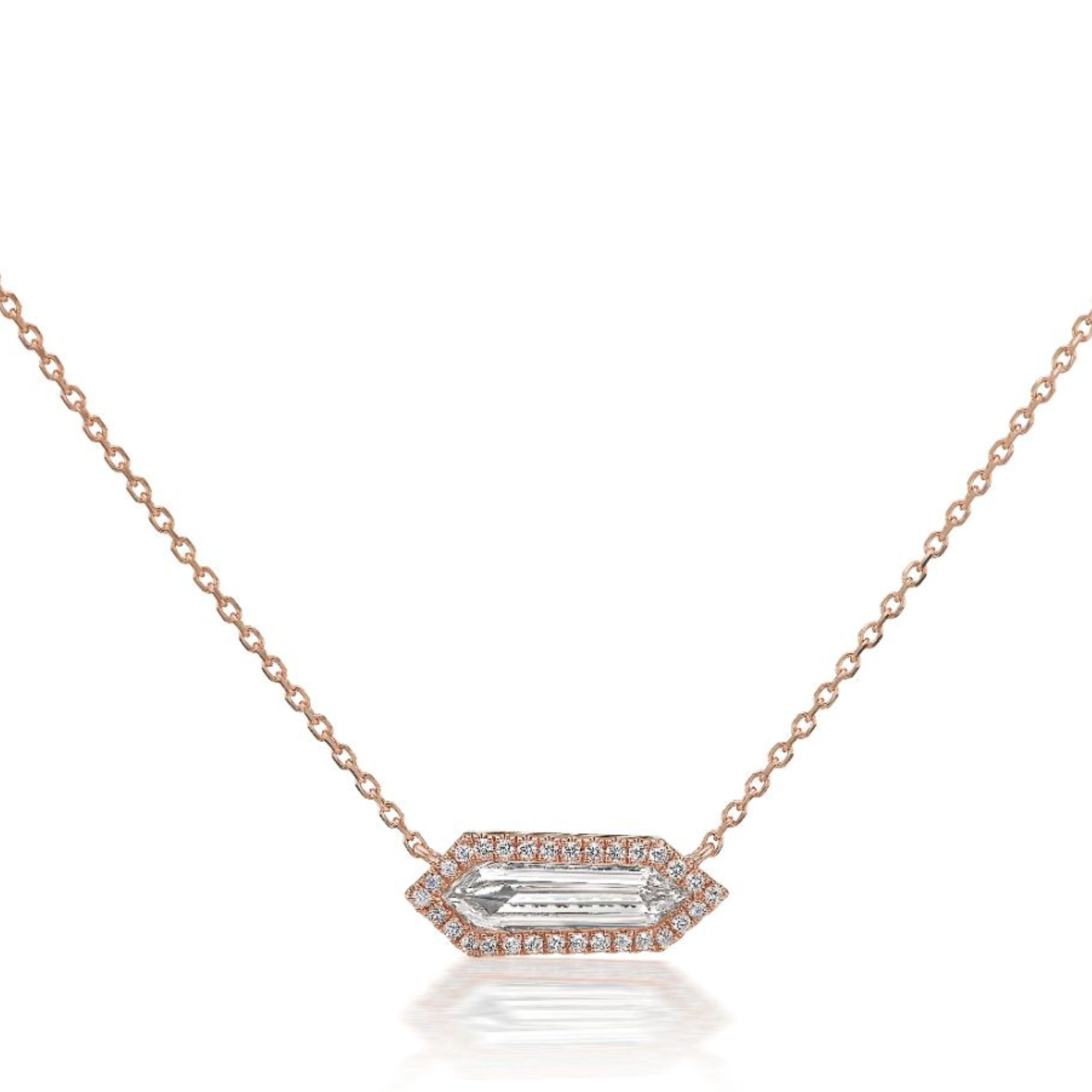 The Hexagon Diamond Pavé Pendant is a delicate 18K rose gold chain necklace with an elongated hexagon pavé pendant, featuring a central clear gemstone encircled by sparkling diamonds.