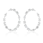 The Light Mixed Shape Diamond Hoops are large white metal earrings featuring G-H color diamonds in round, oval, rectangular, and marquise cuts arranged along the entire hoop.