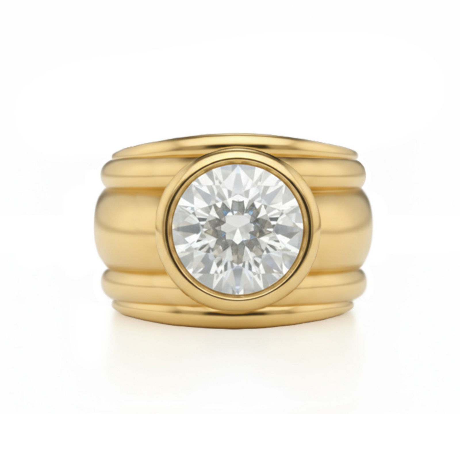 The Chunky Bezel Set Round Diamond Engagement Ring in Yellow Gold features a smooth, polished band with a large, round brilliant-cut bezel set diamond at the center, shown on a white background to highlight its shine and elegant design.