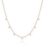 The Spike Ball Station Chain Necklace with Pear Diamonds showcases seven evenly spaced pear-shaped diamonds set in 18k gold, blending minimalist design with timeless elegance for a sophisticated look.