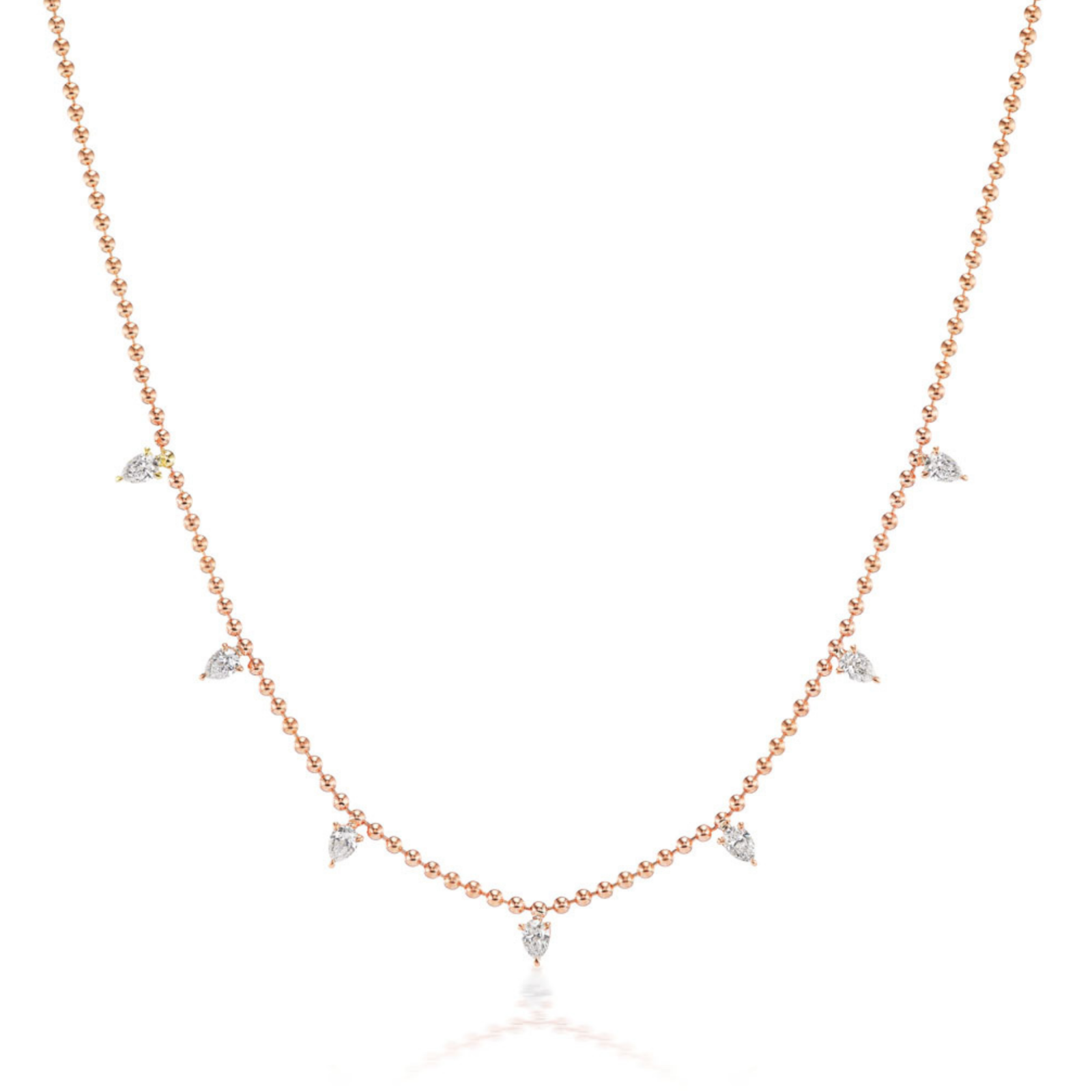 The Spike Ball Station Chain Necklace with Pear Diamonds showcases seven evenly spaced pear-shaped diamonds set in 18k gold, blending minimalist design with timeless elegance for a sophisticated look.