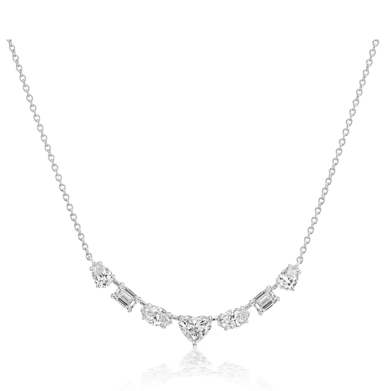 The Mixed Shape Diamond Pendant Necklace features a central heart-shaped diamond, flanked by round and rectangular diamonds in a symmetrical design on an 18K gold chain. Displayed against a plain white background.
