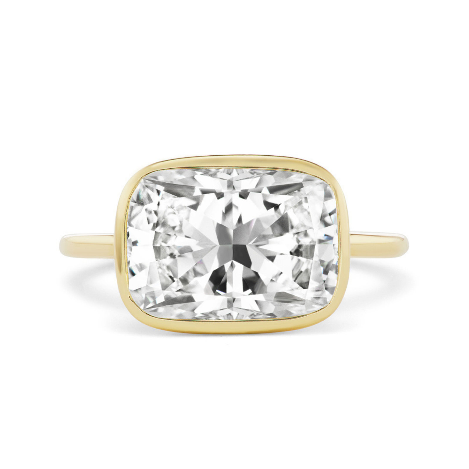 The East-West Bezel Set Cushion Cut Diamond Engagement Ring features a large cushion-cut diamond in a sleek bezel setting—an exquisite, elegant choice for those seeking bespoke design.