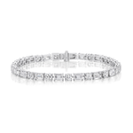 Introducing the Alternating East-West Set Round and Emerald Cut Diamond Tennis Bracelet in White Gold, featuring both round and emerald cut diamonds set in an elegant alternating pattern against a sleek white gold backdrop.