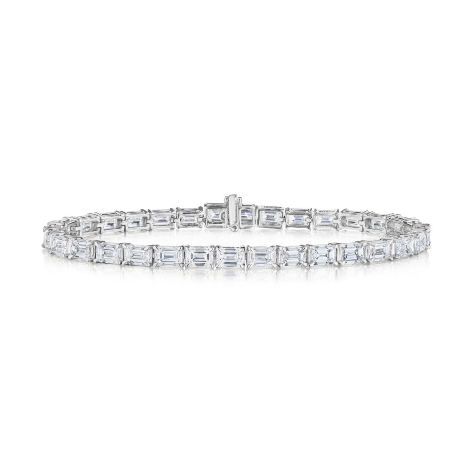 The East-West Emerald Cut Tennis Bracelet showcases emerald-cut diamonds set in a continuous row on an 18K white gold band, displayed against a white background.