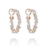 The Mixed Shape Diamond Hoops feature 18K gold and dazzling round, oval, and baguette-cut diamonds that sparkle elegantly along the outer edge.