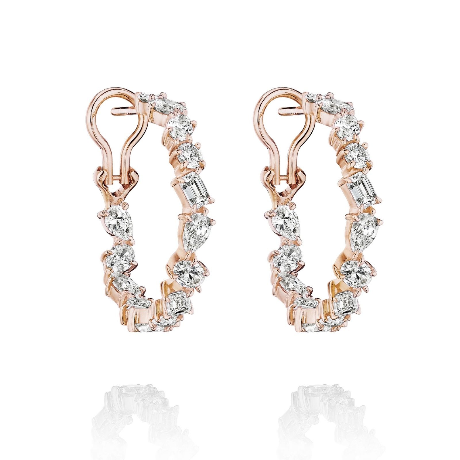 The Mixed Shape Diamond Hoops feature 18K gold and dazzling round, oval, and baguette-cut diamonds that sparkle elegantly along the outer edge.