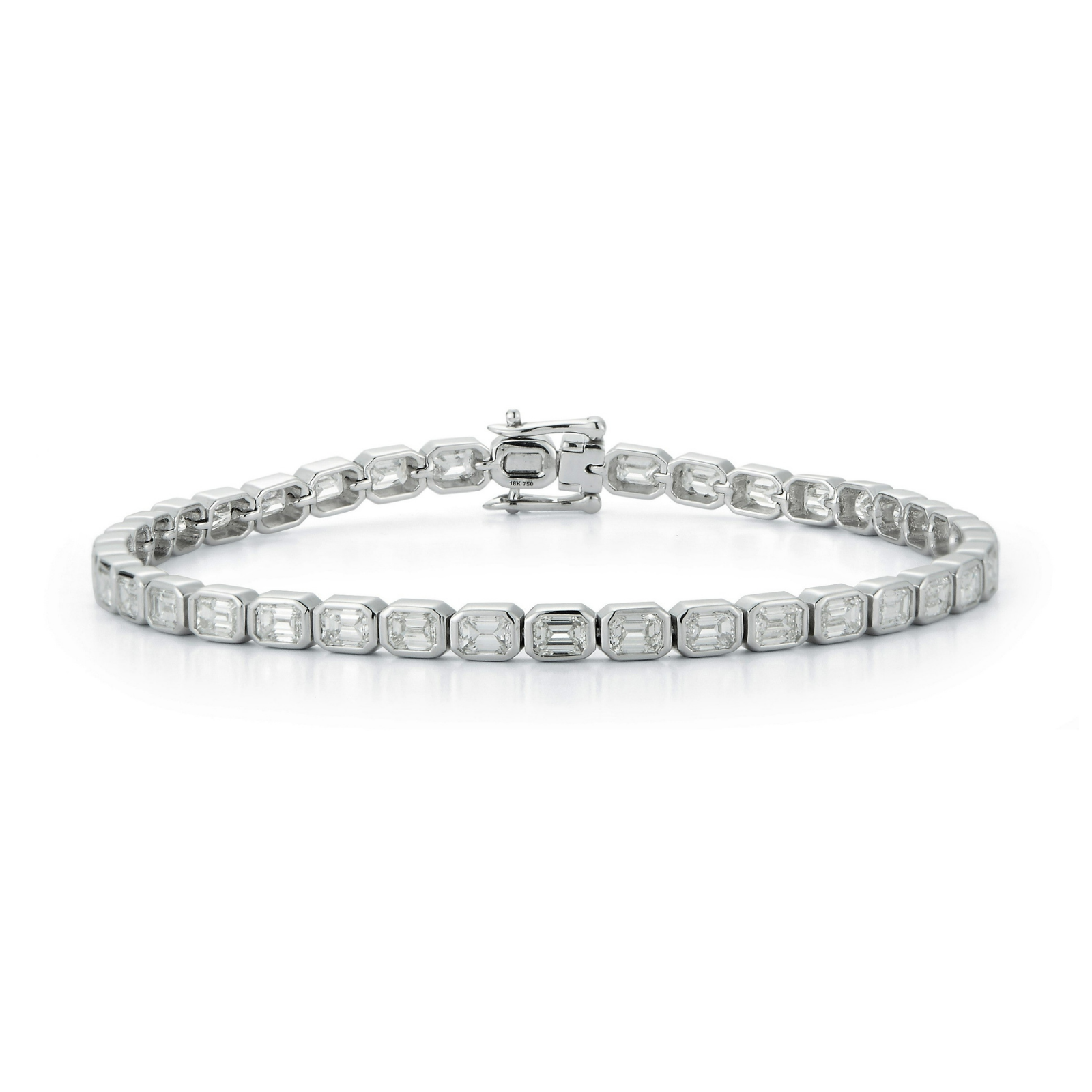 Introducing the East-West Emerald Cut Bezel Bracelet, showcasing a continuous row of bezel-set emerald cut diamonds in 18k white gold with a secure clasp, elegantly displayed on a white background.