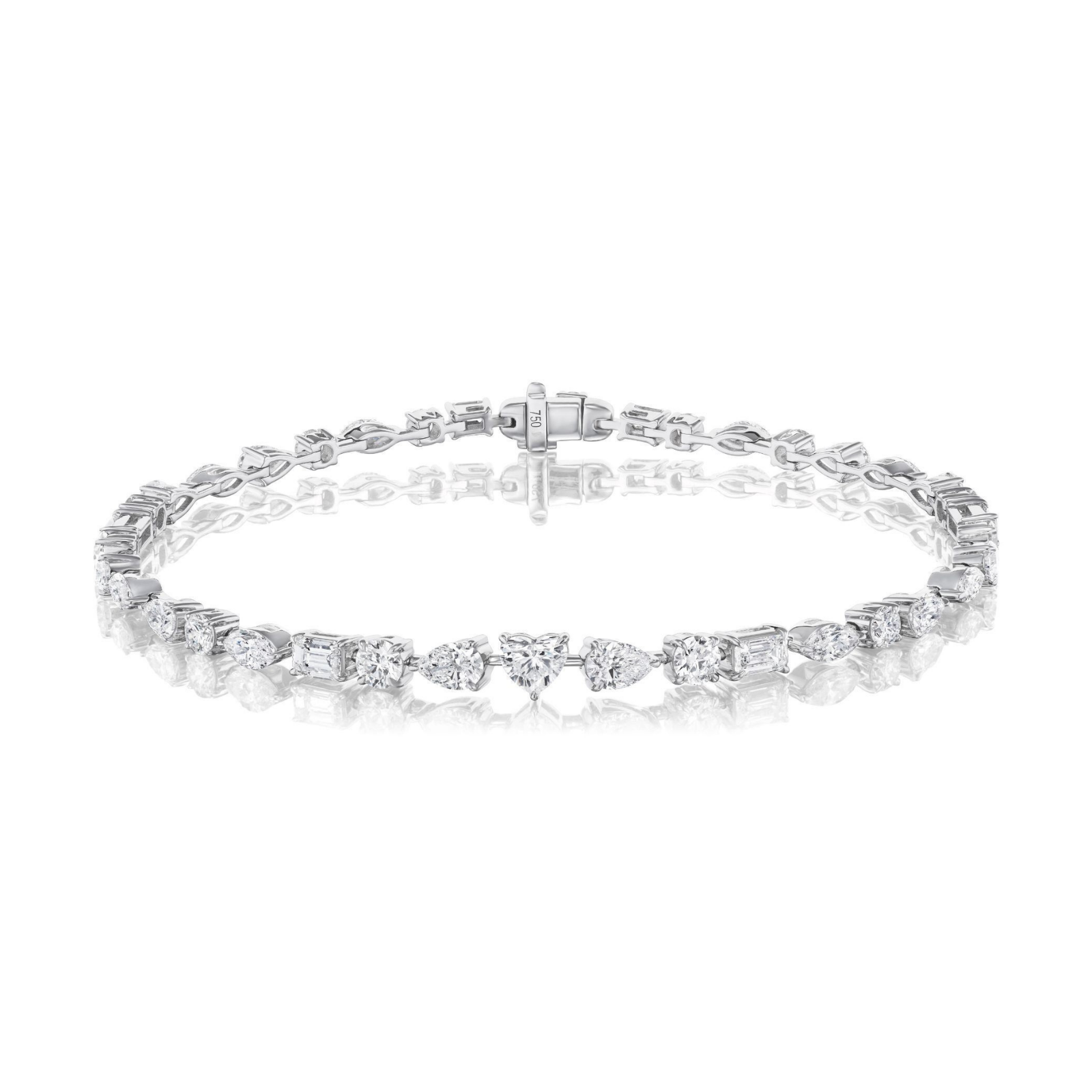 The East-West Mixed Shape Tennis Bracelet is a delicate silver piece showcasing alternating round and emerald-cut clear gemstones, presented on a white background with a shiny reflection below.