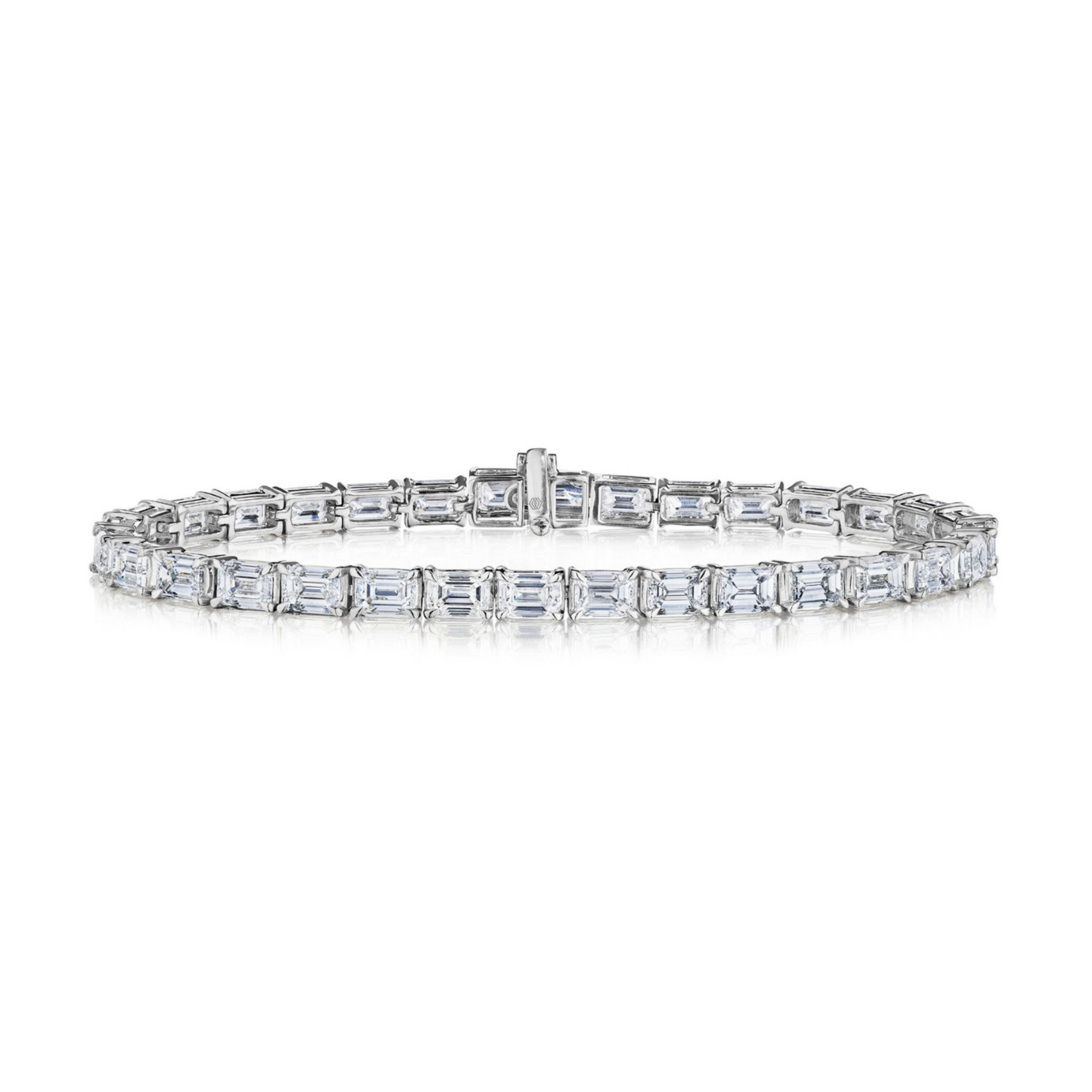 Introducing the Large East-West Emerald Cut Diamond Tennis Bracelet in White Gold—an exquisite piece crafted from 18K white gold and showcasing a seamless row of rectangular emerald cut diamonds with VS clarity, set closely together to form a continuous and elegant circle.
