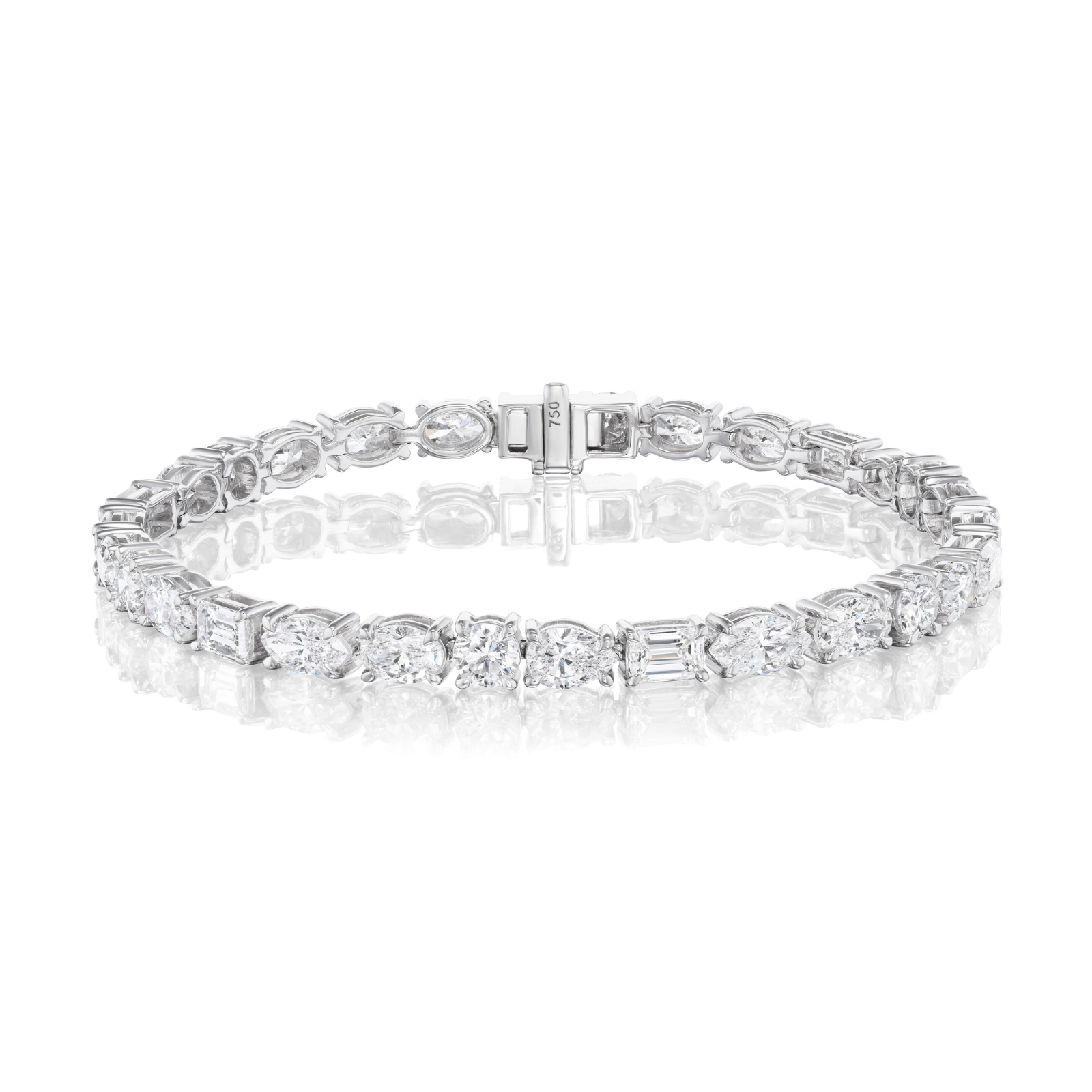 The Medium East-West Mixed Shape Diamond Tennis Bracelet showcases an array of mixed shape diamonds set in 18k white gold, elegantly displayed on a white reflective surface.