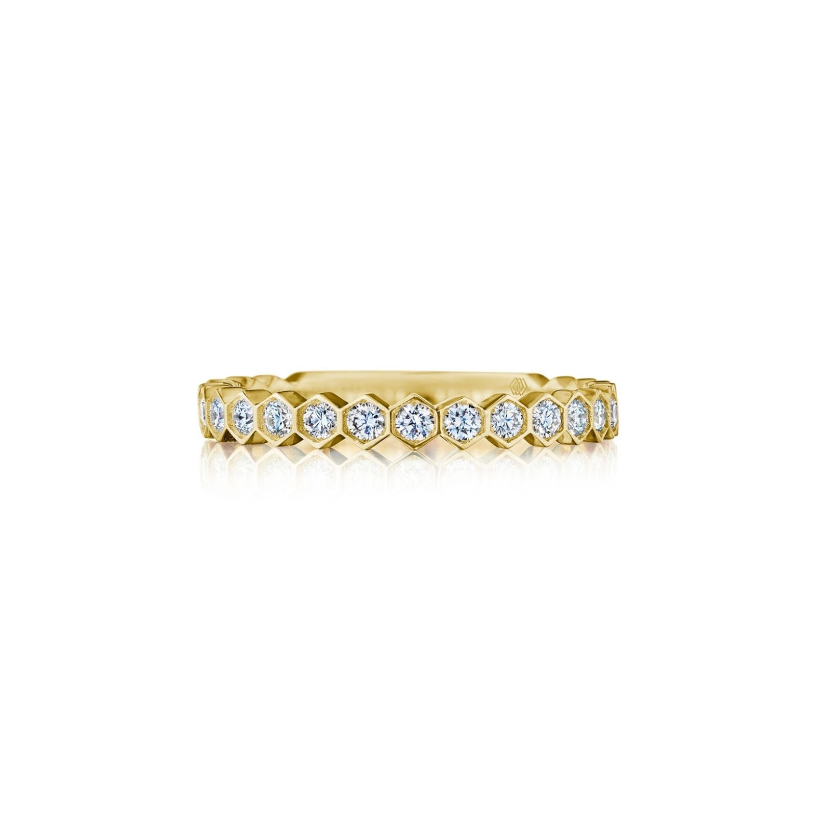 The Hexagon Bezel Set Diamond Band in 18k gold showcases round white diamonds in a geometric pattern, elegantly bezel set and photographed on a white background.