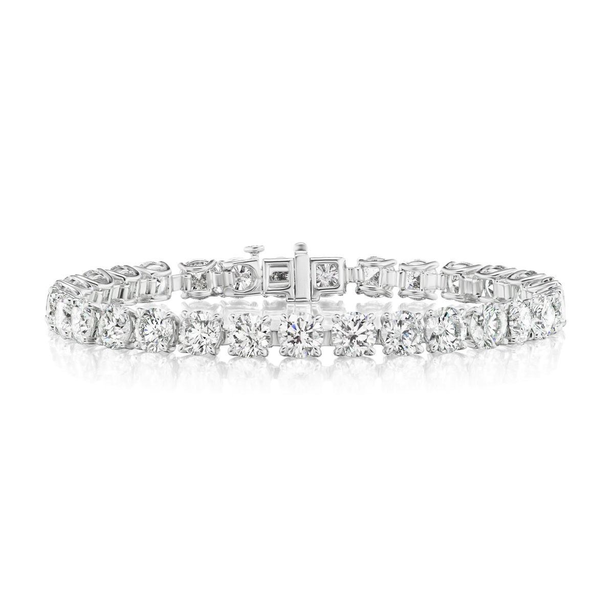 The Large Round Brilliant Diamond Tennis Bracelet in White Gold showcases a single row of sparkling round diamonds set in an elegant 18K white gold band, elegantly displayed on a white background.