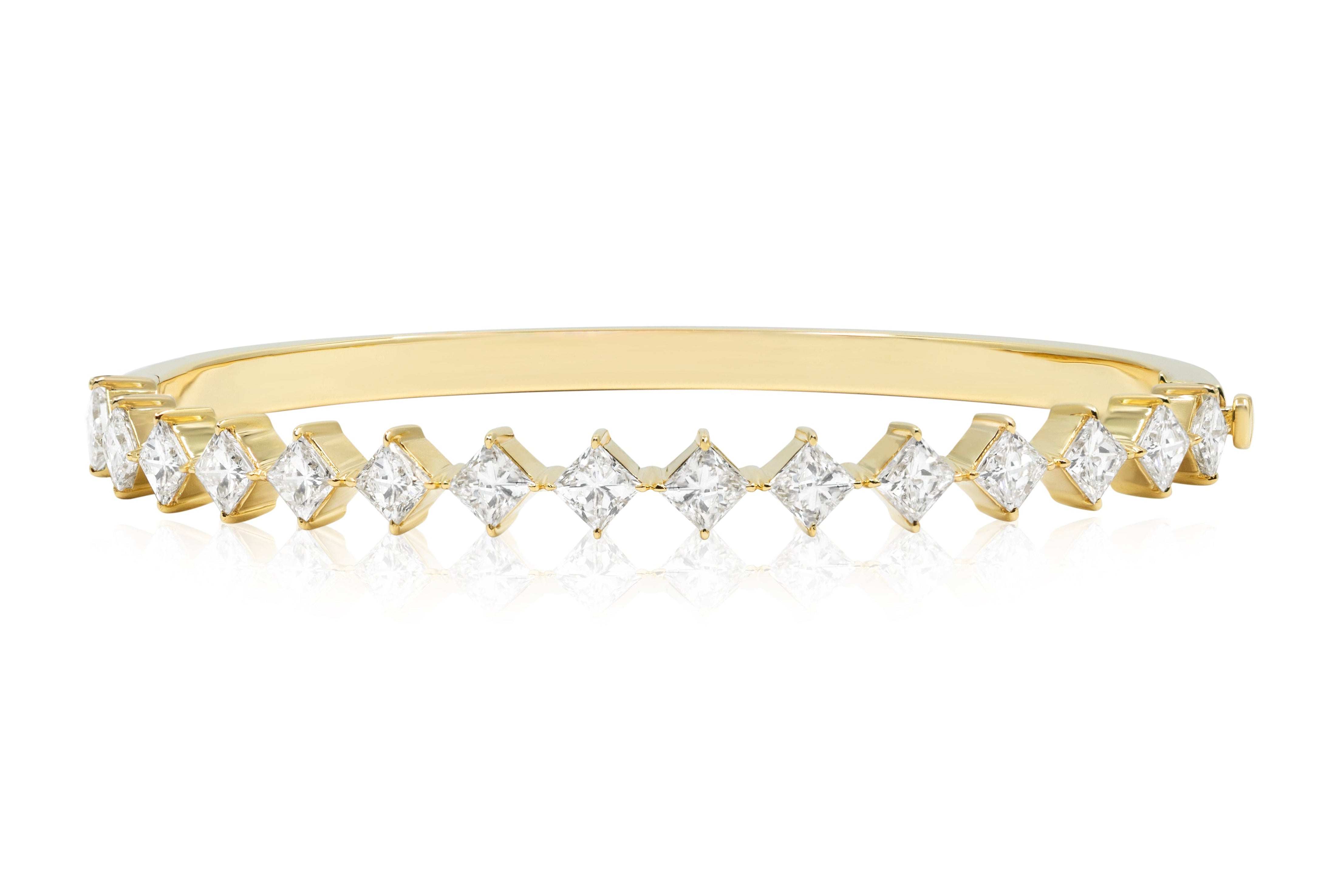 The Diagonally Set Square Diamond Bangle in Yellow Gold features square diamonds set diagonally along the top, elegantly crafted in 18K yellow gold.