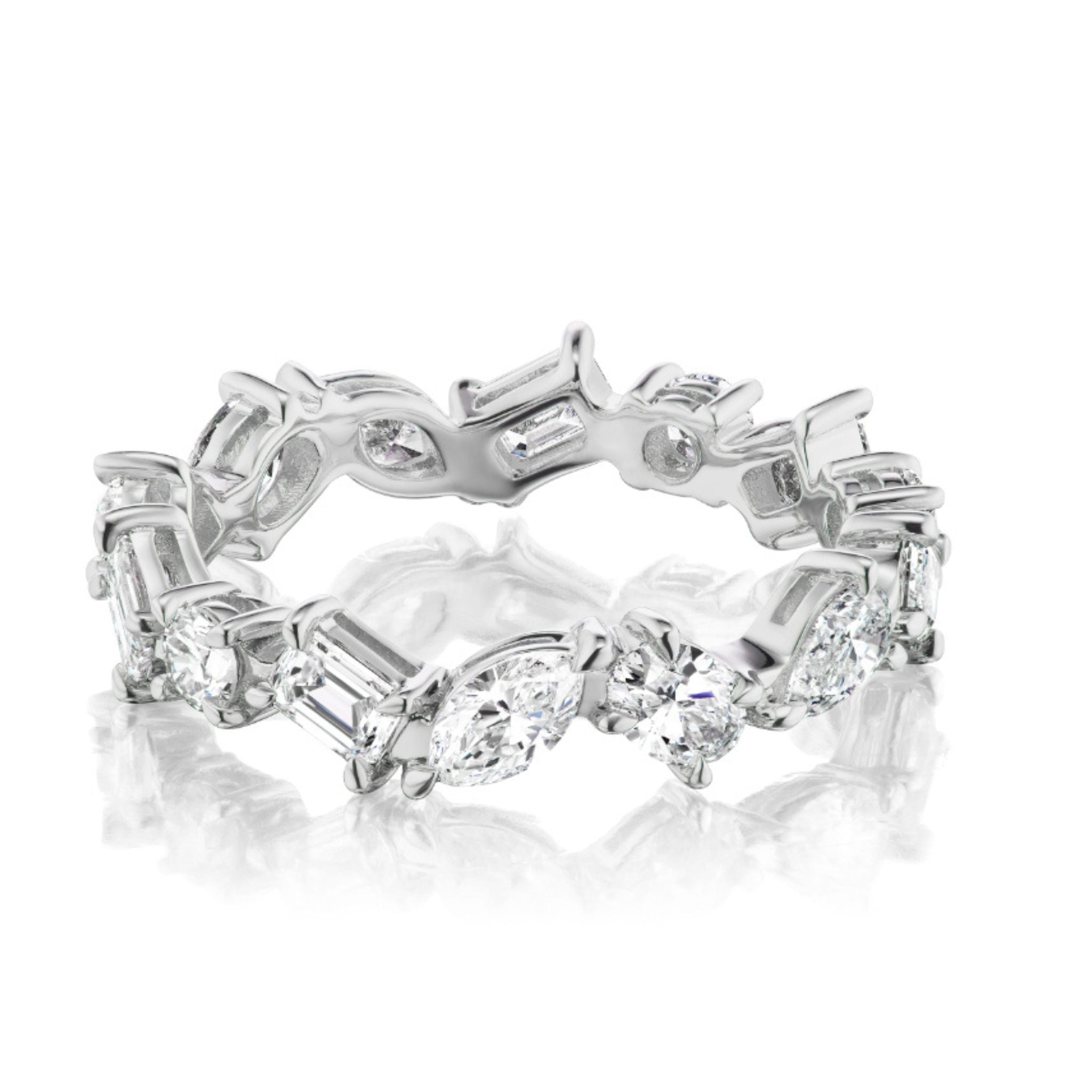 The Mixed Shape Diamond Eternity Band features marquise, baguette, and round diamonds set in an intricate 18K white gold continuous design.