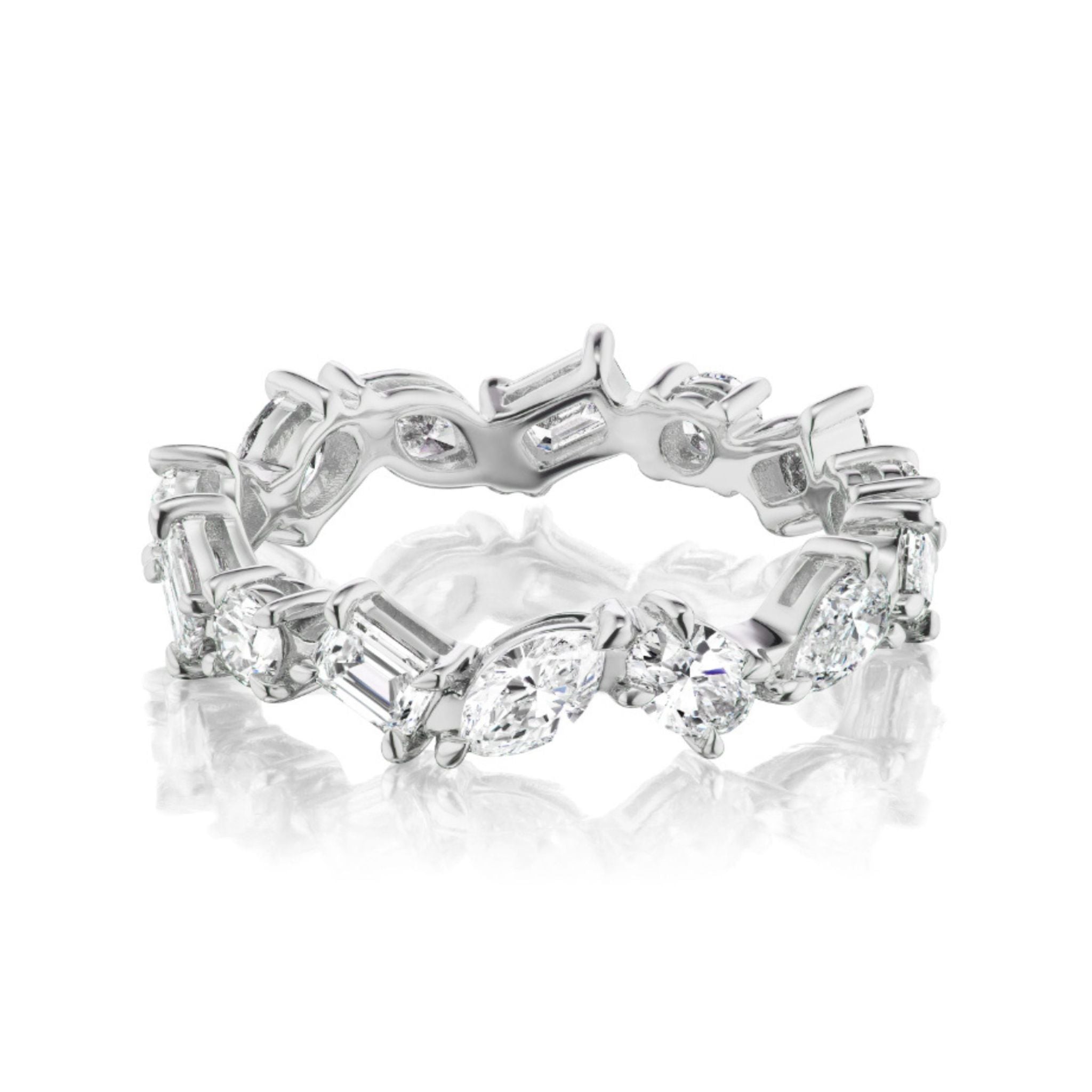 The Mixed Shape Diamond Eternity Band features marquise, round, and baguette diamonds in an alternating pattern, set in white gold. This Celebration & Bridal ring shines with a reflective surface and intricate design.