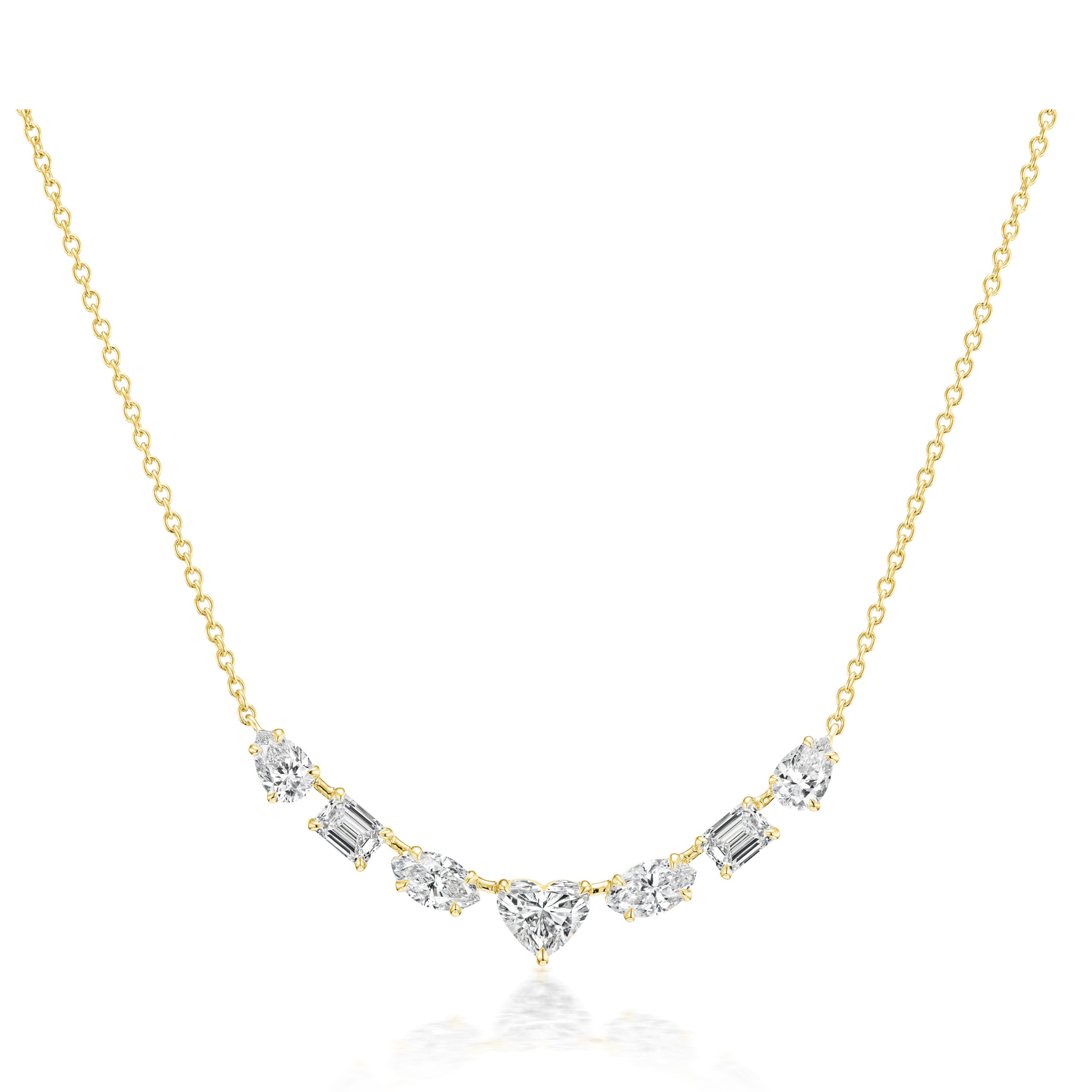 The Mixed Shape Diamond Pendant Necklace features a delicate 18K gold chain with a row of diamonds in various shapes, including a heart-shaped center stone, all arranged in a graceful curve.