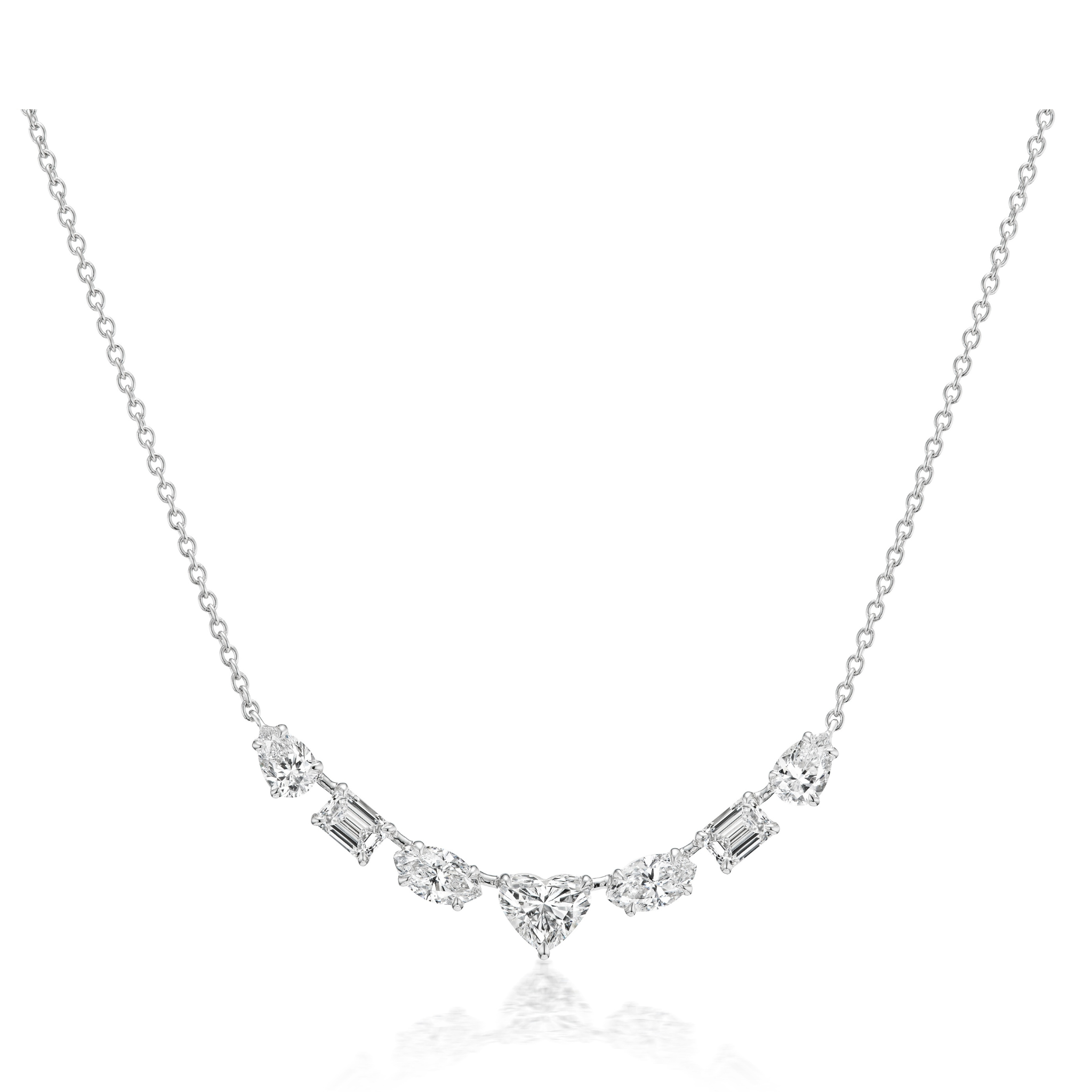 The Mixed Shape Diamond Pendant Necklace features a delicate silver chain and a central heart-shaped diamond, accented by round and rectangular gemstones in a symmetrical design.