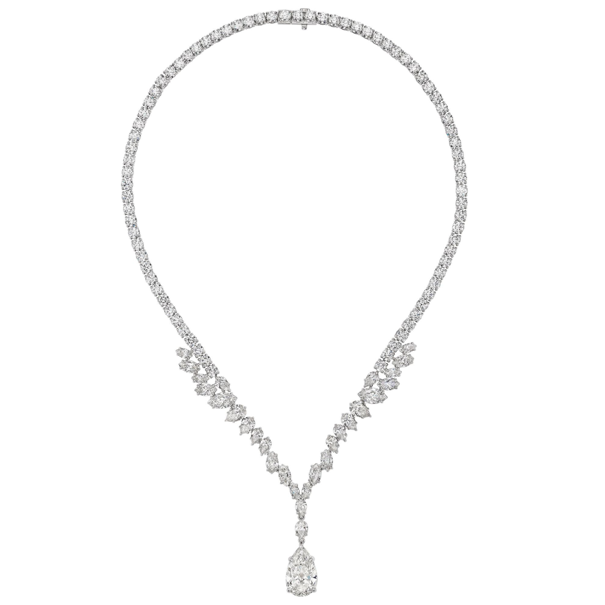 The Mixed Shape Diamond Tennis Necklace in White Gold features a symmetrical design with clustered mixed shape diamonds and a striking pear-shaped diamond pendant at the center.