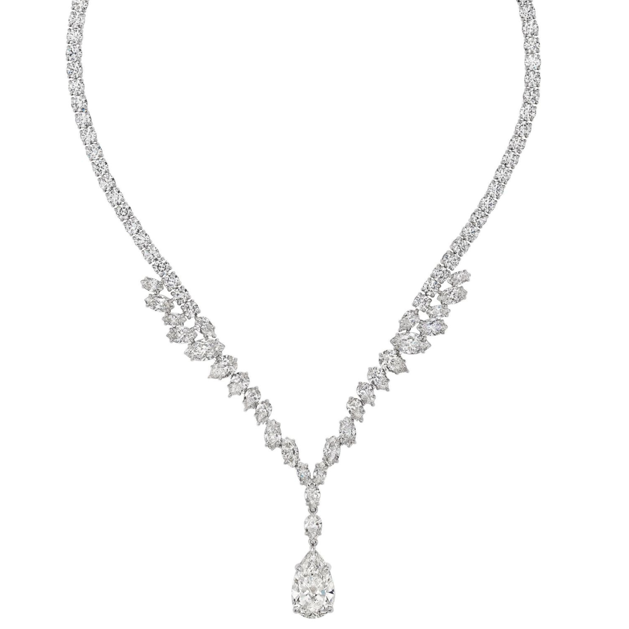 The Mixed Shape Diamond Tennis Necklace in White Gold features a symmetrical design with clusters of mixed shape diamonds on each side and a prominent teardrop-shaped diamond pendant at the center.