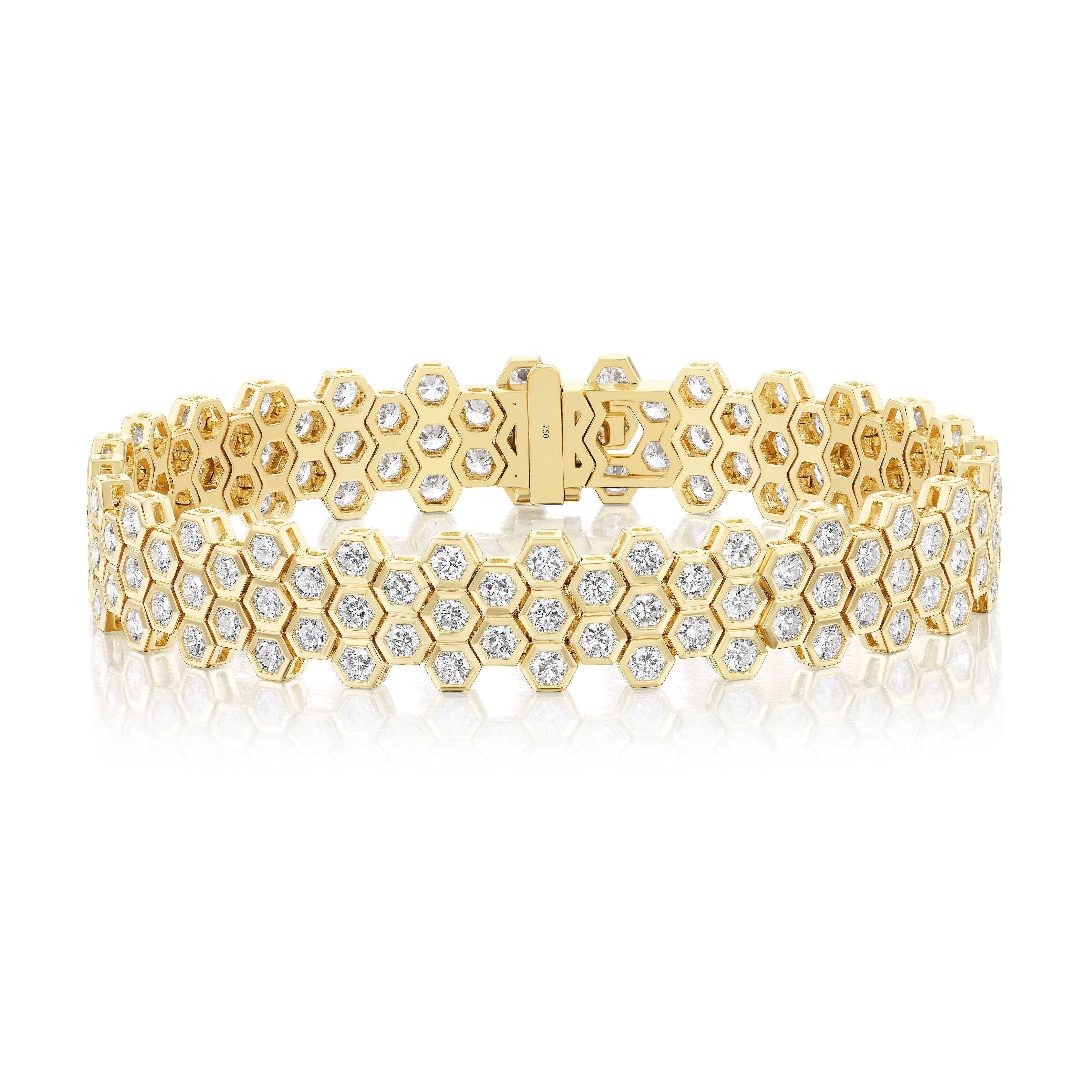 The Multi-Tier Hexagon Bezel Set Tennis Bracelet in yellow gold showcases a honeycomb-inspired design, with each hexagonal bezel holding a brilliant round diamond, displayed on a white background.