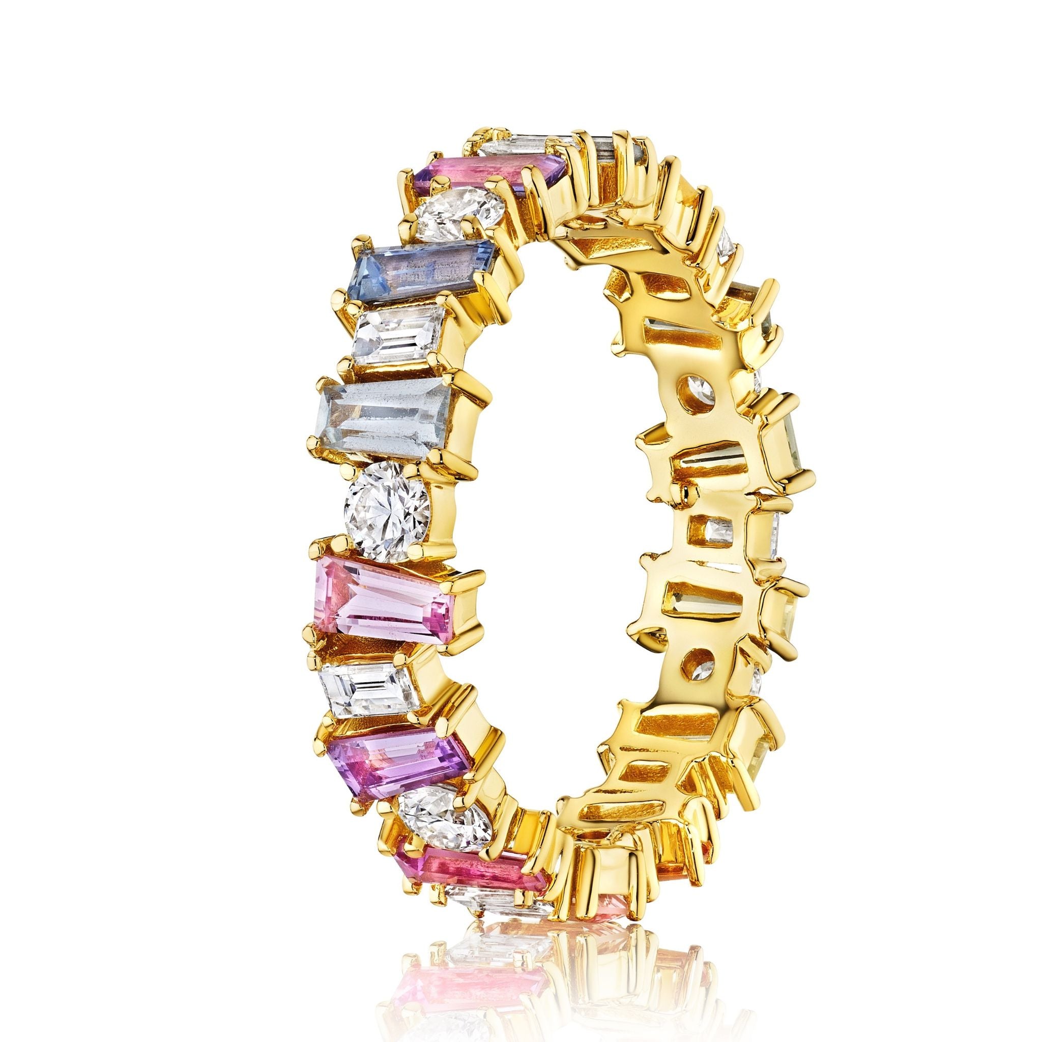 The Multicolor Eternity Band in Yellow Gold features alternating round diamonds and tapered baguette sapphires in pink, blue, purple, and clear shades set in a continuous 18K yellow gold band.