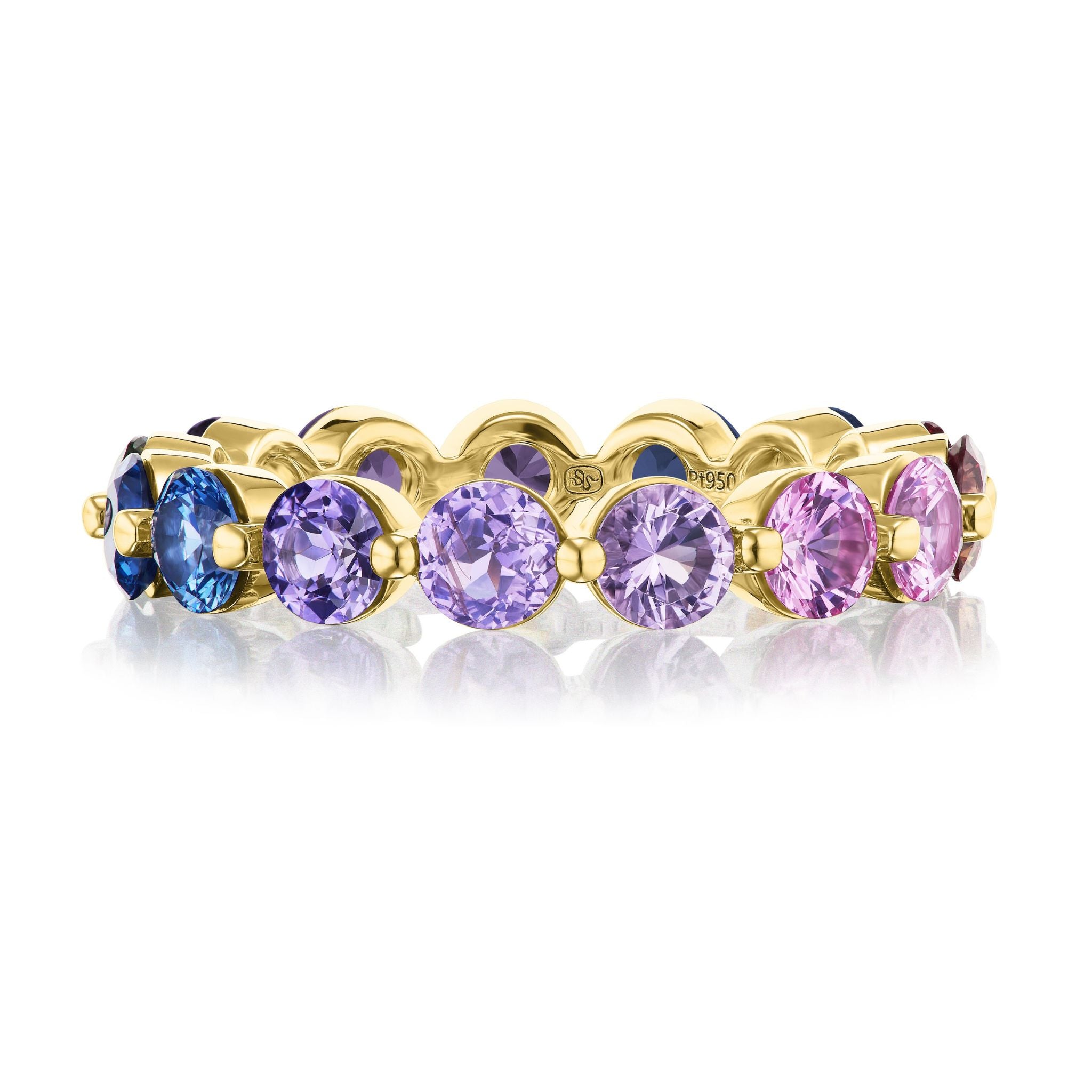 The Multicolor Round Sapphire Eternity Band in Yellow Gold features gradient blue, purple, and pink sapphires set in 18K gold, photographed on a white background with its reflection underneath.