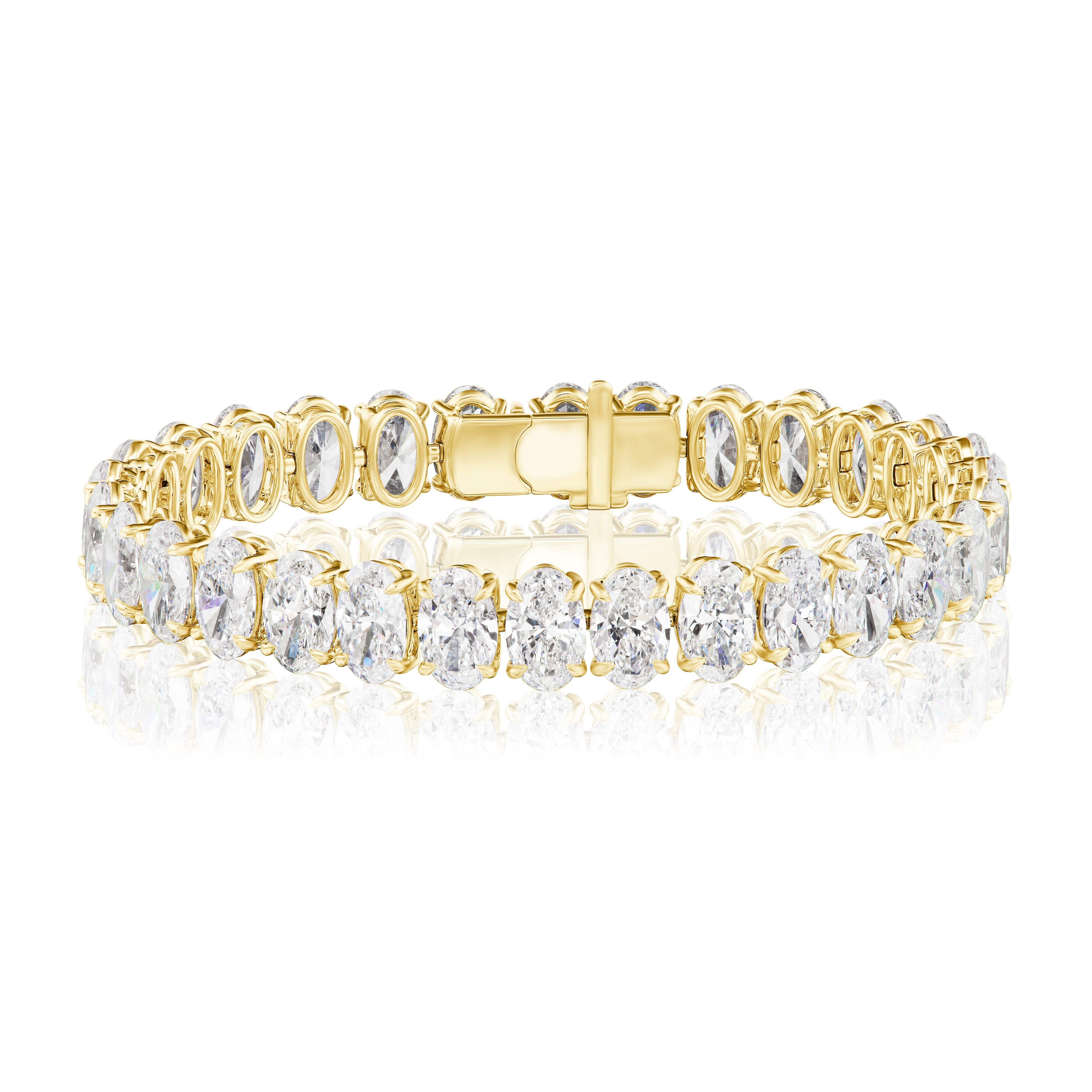 The North-South Set Oval Shape Tennis Bracelet in yellow gold showcases large D-F color diamonds in an elegant row, set in 18k yellow gold and secured with a box clasp, beautifully displayed on a reflective white surface.