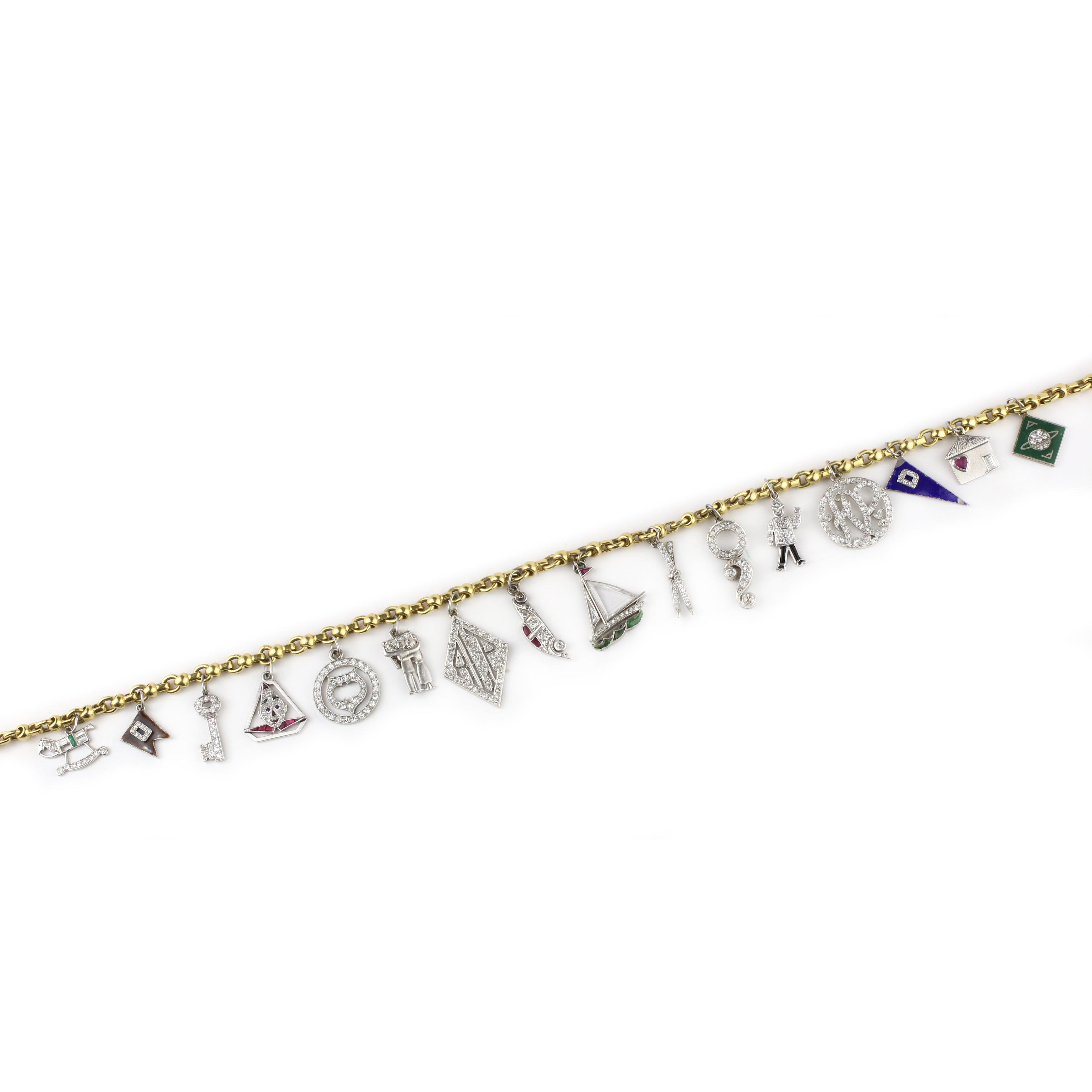 The Art Deco Charm Necklace features a delicate gold chain adorned with unique diamond and enamel charms, each inspired by sailing and nautical symbols, beautifully arranged along its length against a white background.