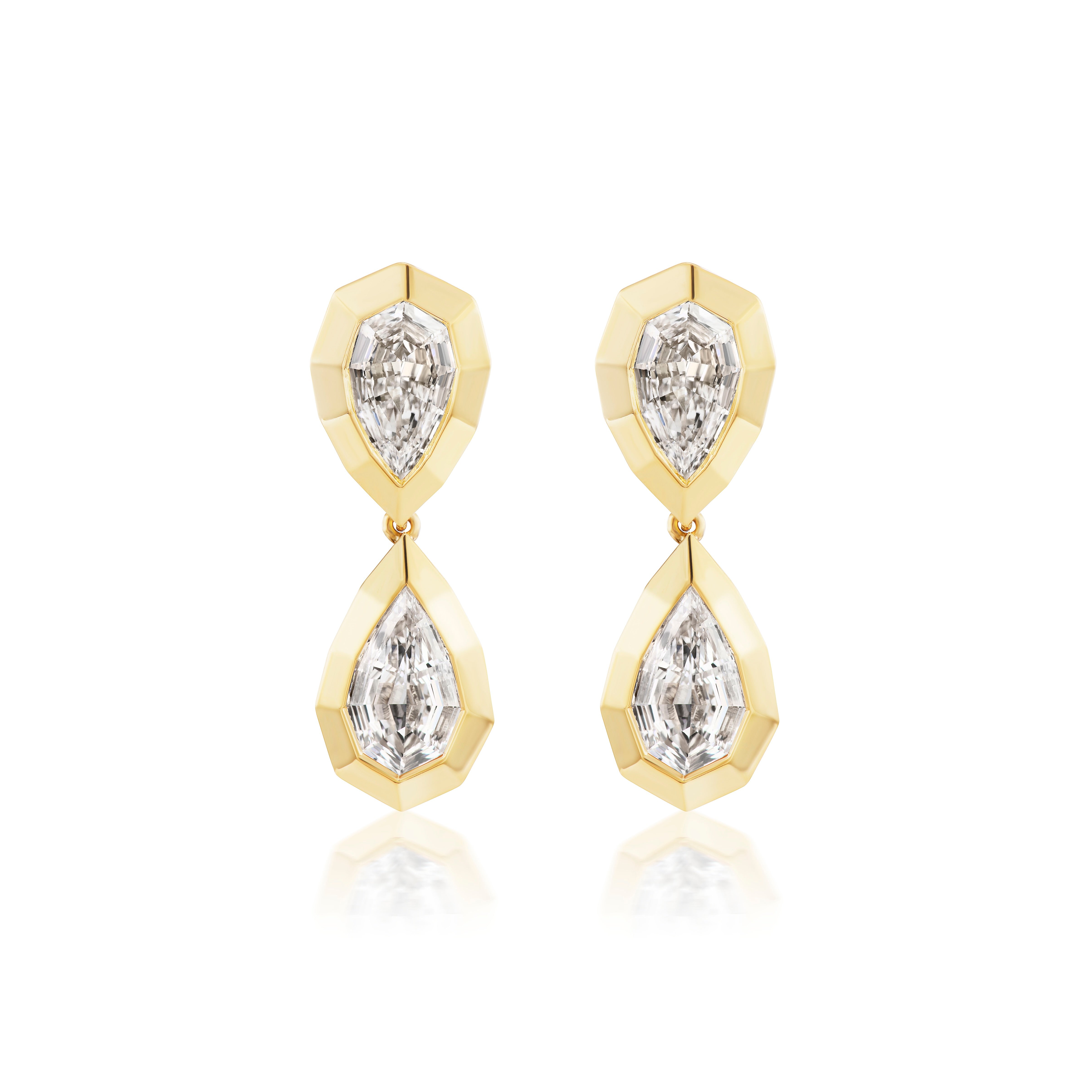 The Bezel Set Step Cut Pear Shape Diamond Drop Earrings in Yellow Gold feature two step cut pear diamonds each in angular yellow gold frames, displayed against a white background.