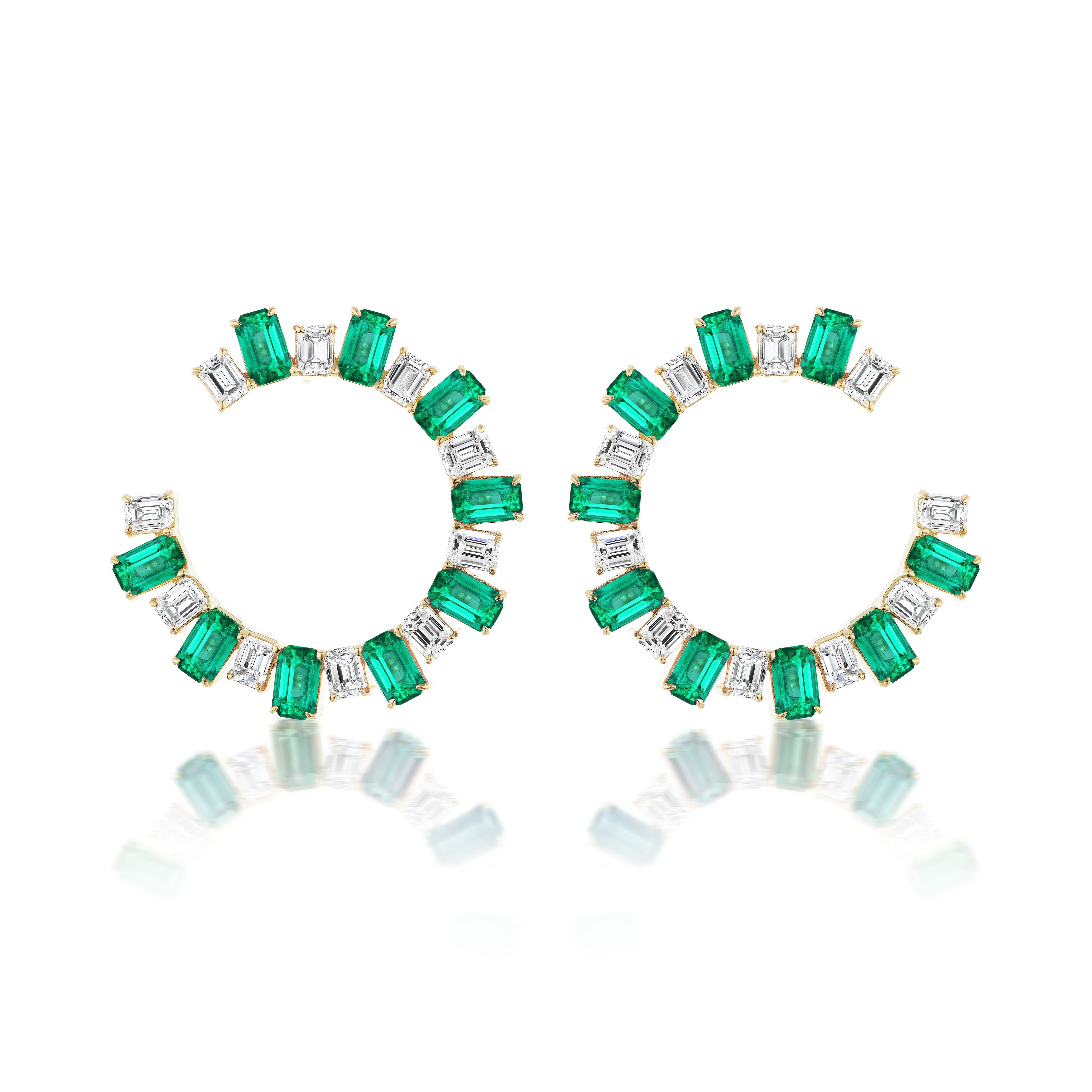 Confetti Front-to-Back Hoops showcase alternating emerald-green gemstones and emerald cut diamonds set in 18K yellow gold, forming open circular hoops with a reflective finish.