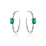 The Pavé Hoops with Emerald Cut Emeralds in White Gold feature emerald cut emeralds set in white gold prongs, with pavé diamond detailing on the hoops, shown against a white background.