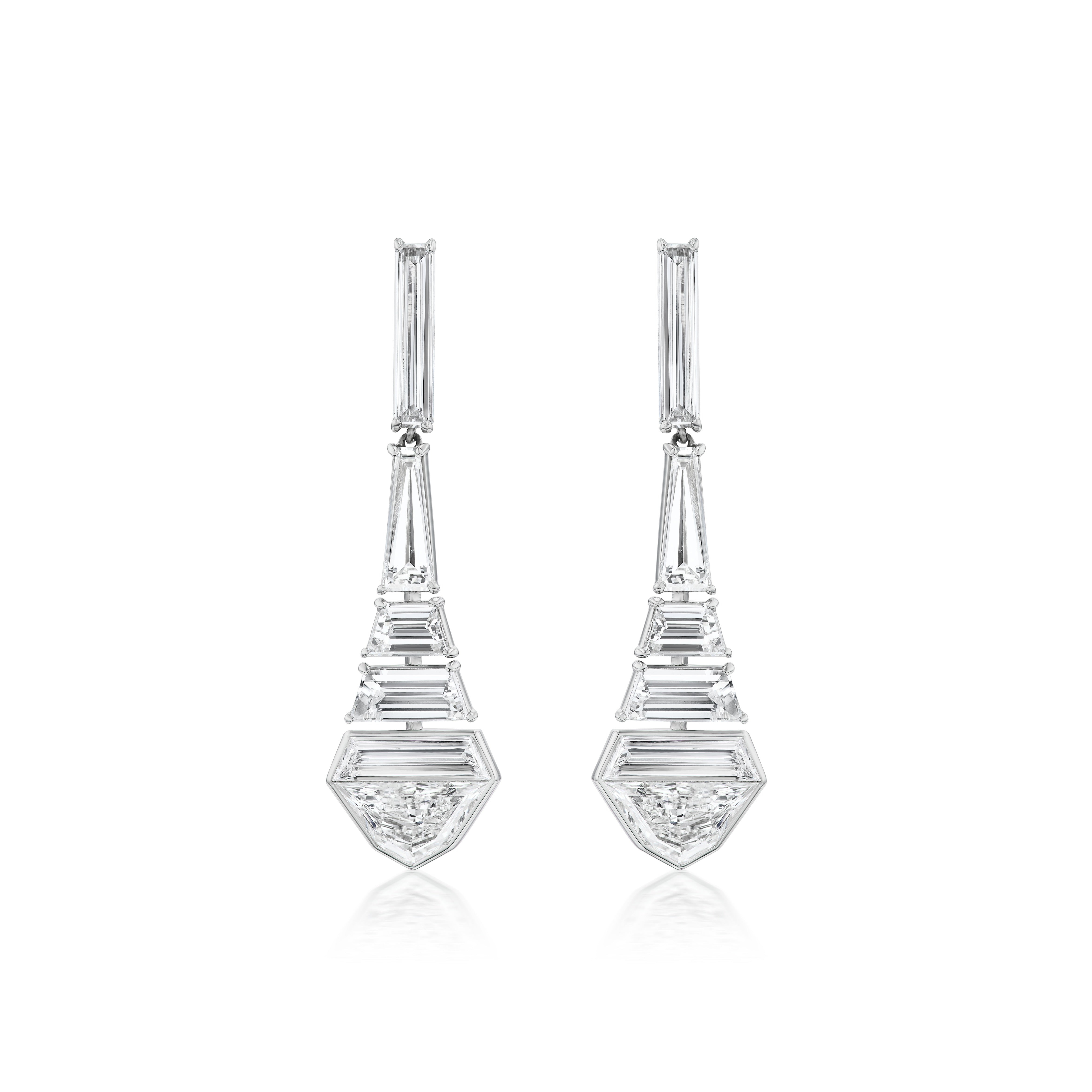 The Statement Baguette Drop Earrings in White Gold showcase elegant, geometric drops with baguette and epaulette diamonds in a stepped pattern, finishing in a hexagonal form topped with a triangular diamond for a modern look.